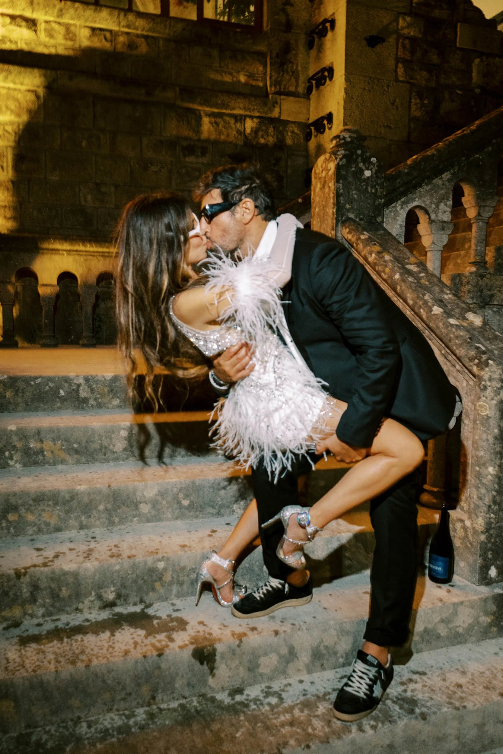 Bride and groom sharing a kiss on the staircase at Forte da Cruz in Estoril, Portugal