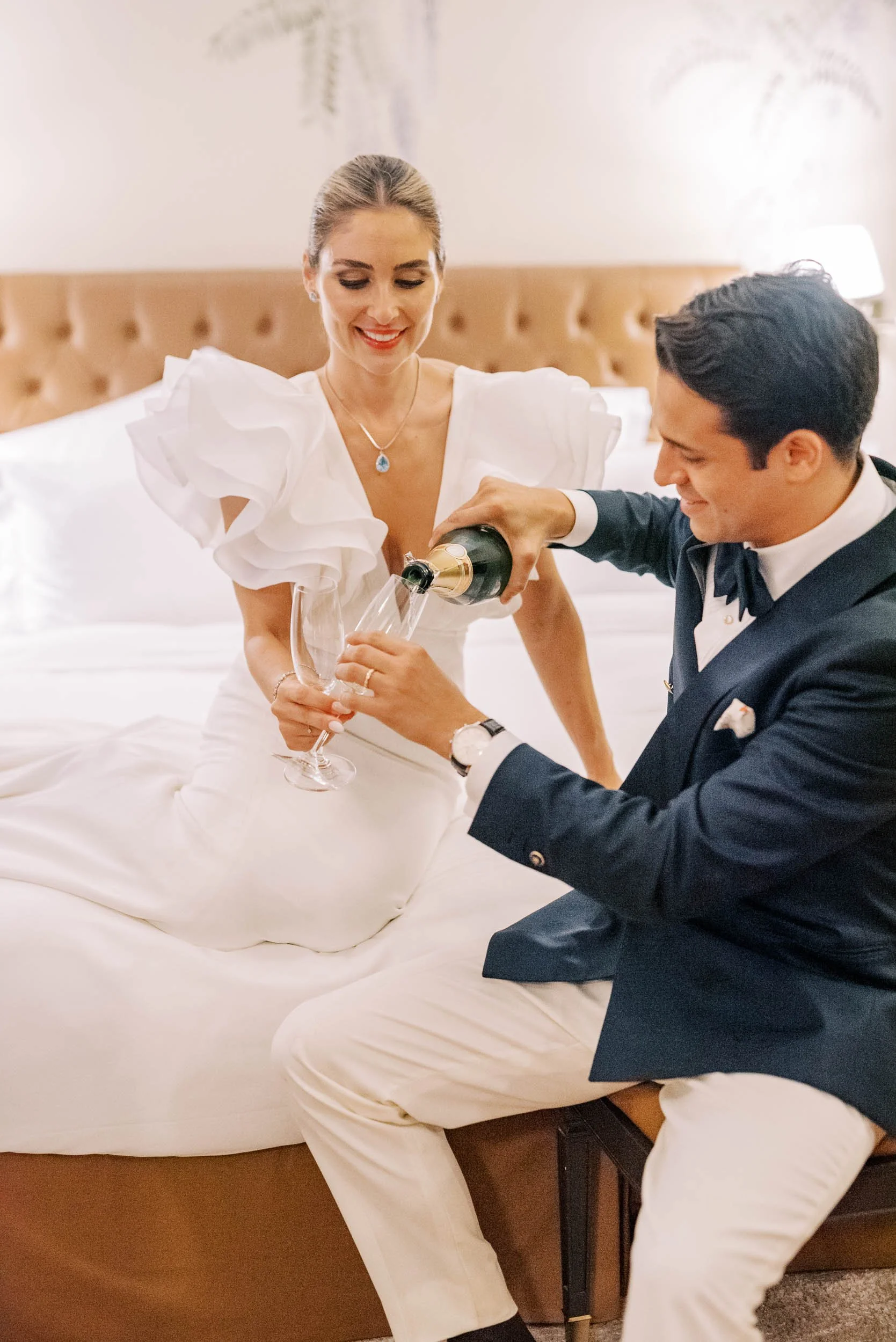 Bride and groom sharing champagne during a wedding at Vidago Palace Hotel in Portugal