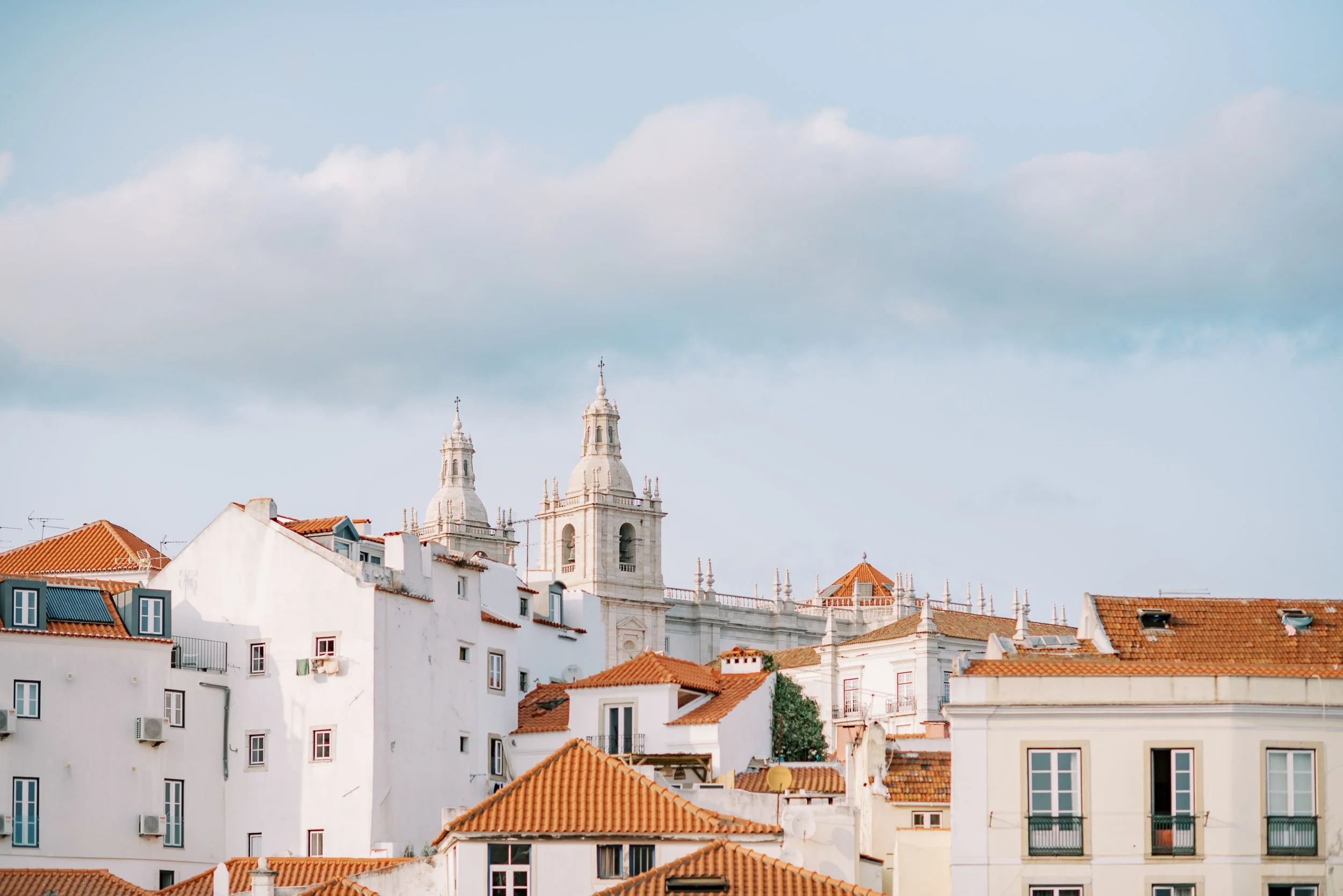Lisbon view with a church in the background during the welcome cocktail before a wedding at Quinta da Bella Vista in Sintra, Portugal