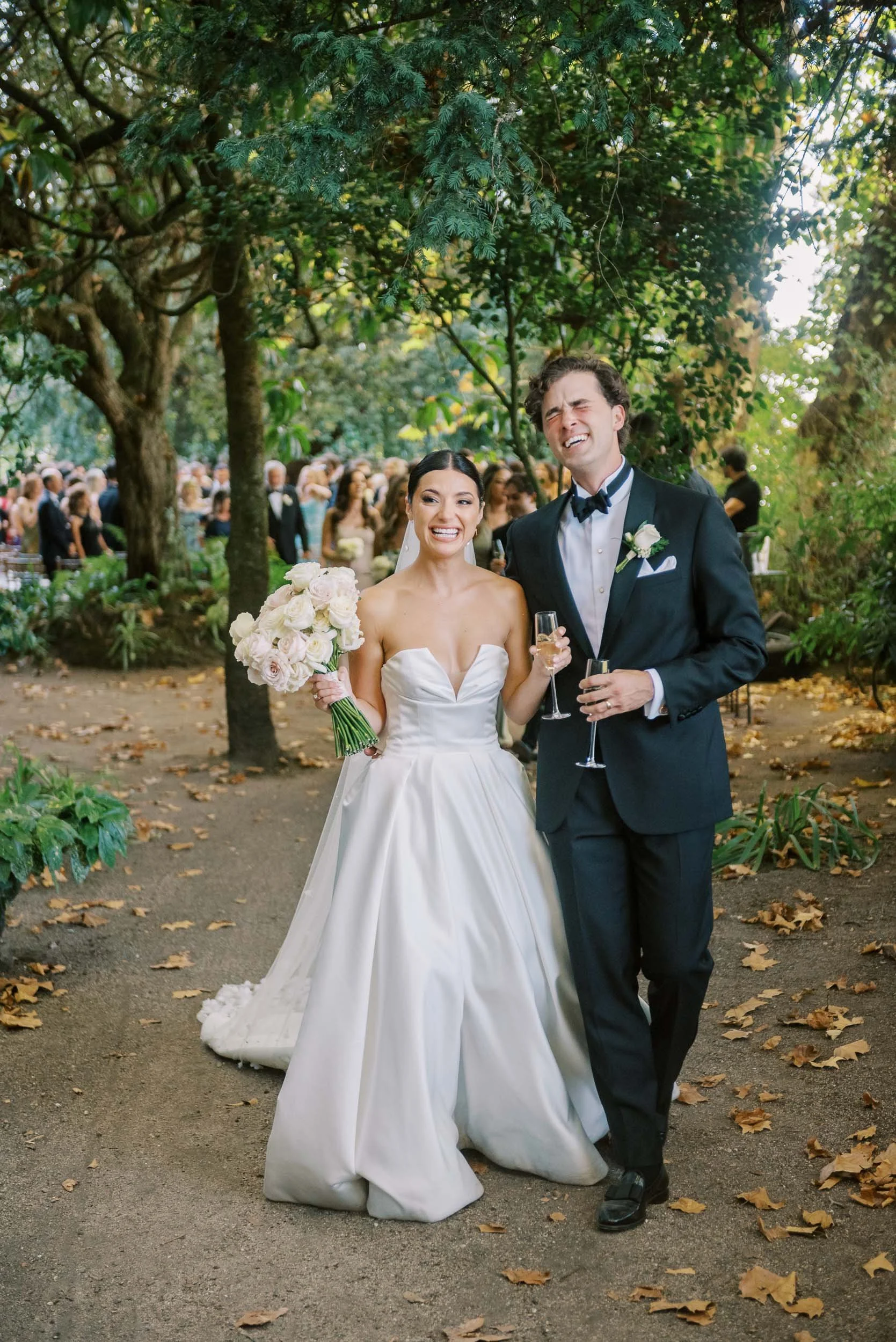 Bride and groom walking through the gardens of Casa dos Penedos in Sintra