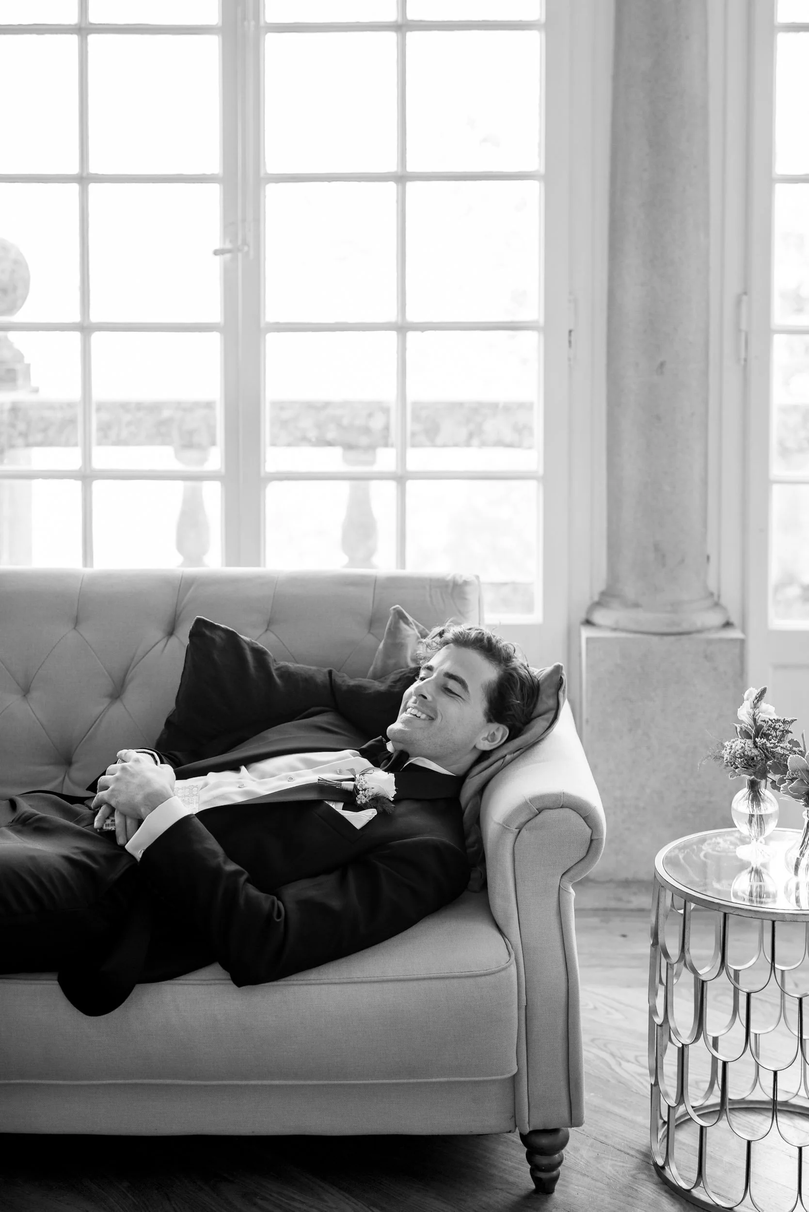 Groom resting on a sofa before the ceremony at Casa dos Penedos in Sintra