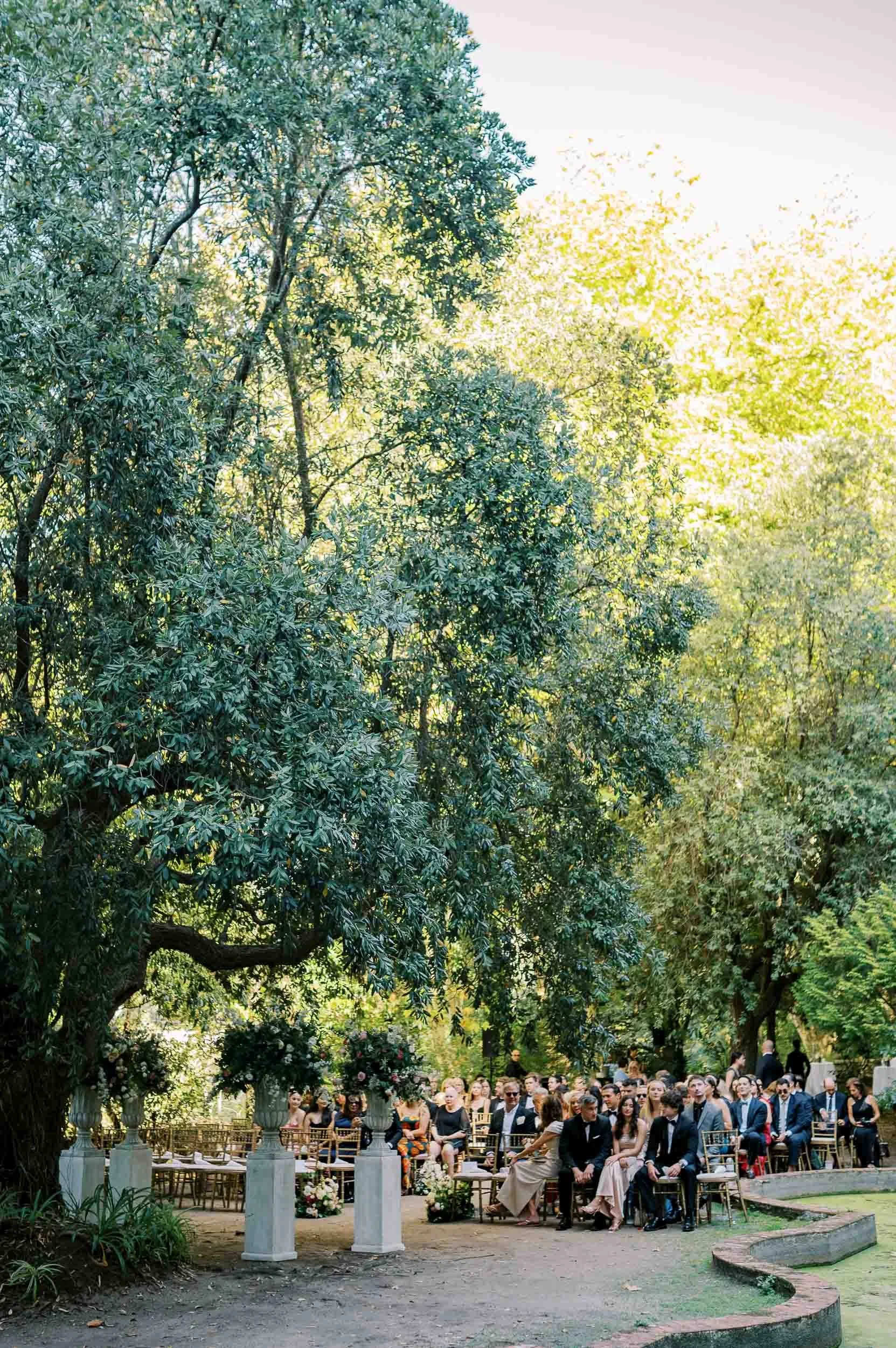 Wedding ceremony beneath the trees at Casa dos Penedos in Sintra