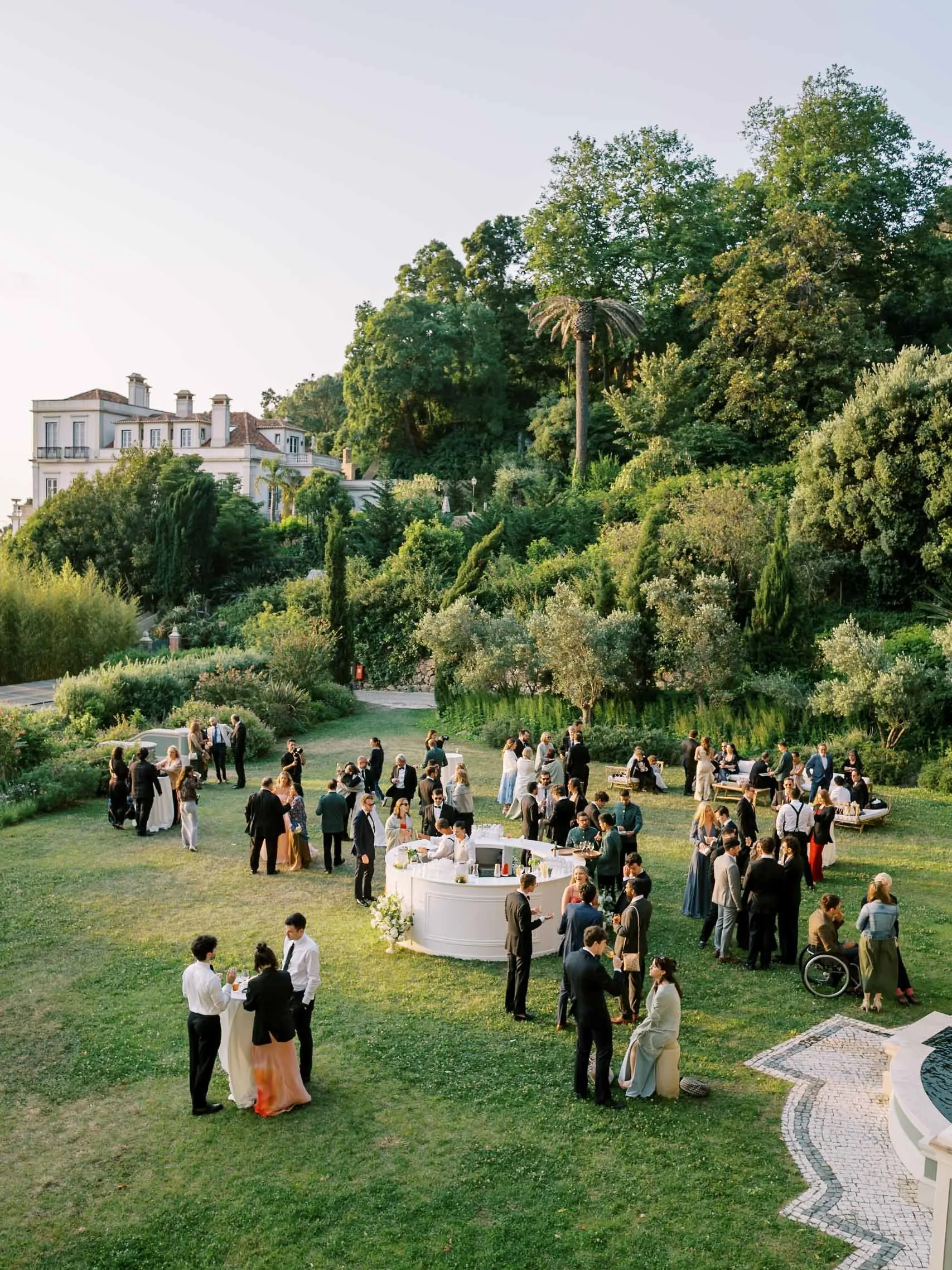 Outdoor wedding reception unfolding in the gardens of quinta da bella vista