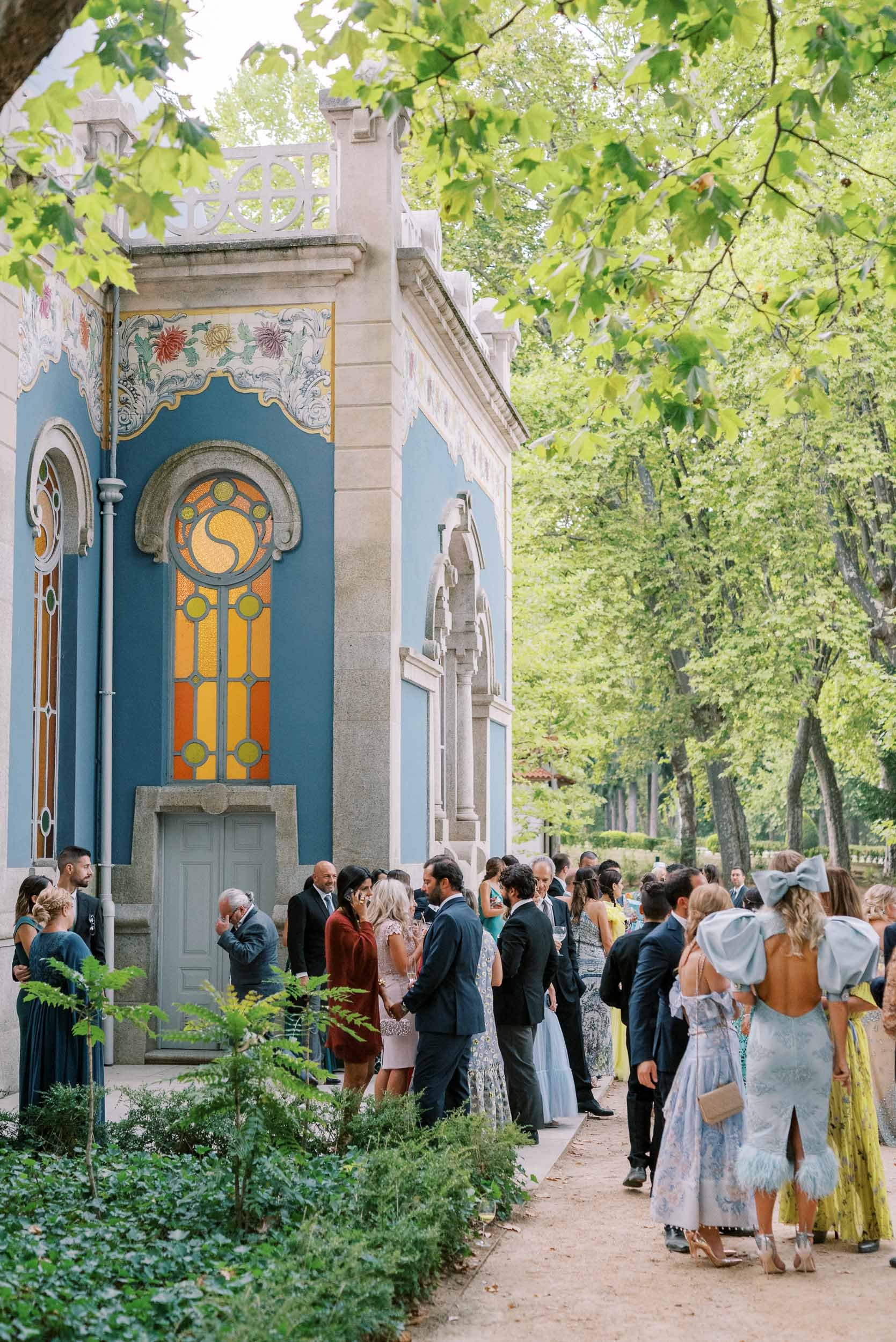 Guests by the by the Art Nouveau pavilion during a wedding at Vidago Palace Hotel in Portugal