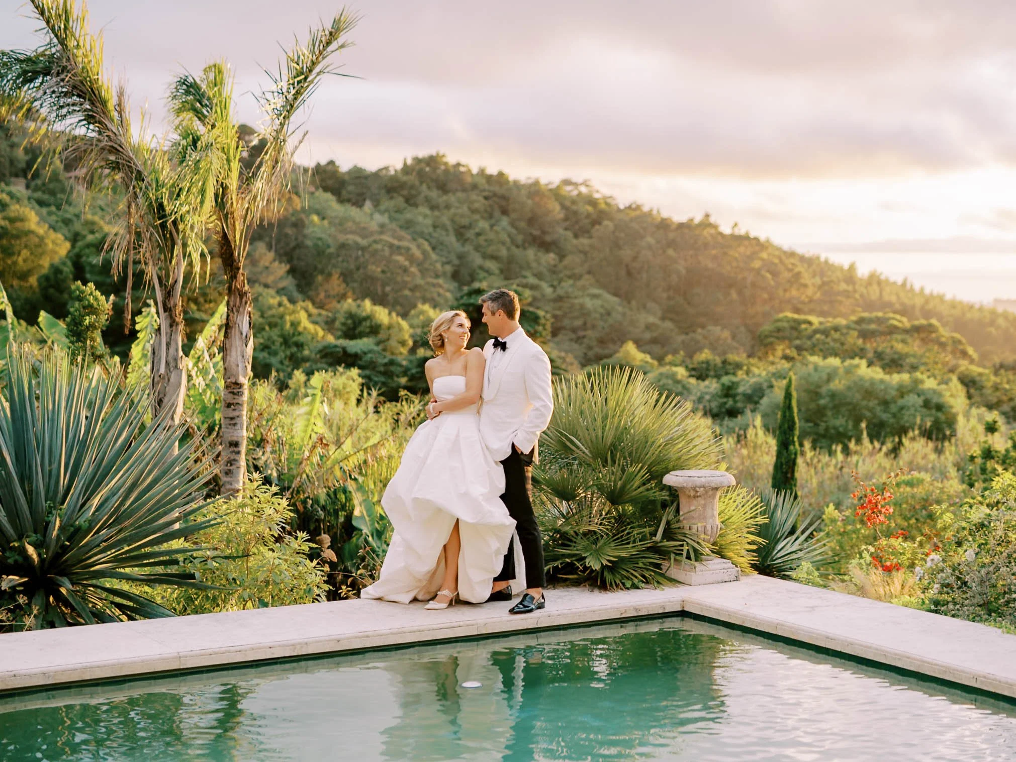 Bride and groom by the pool at sunset at Quinta da Bella Vista in Sintra