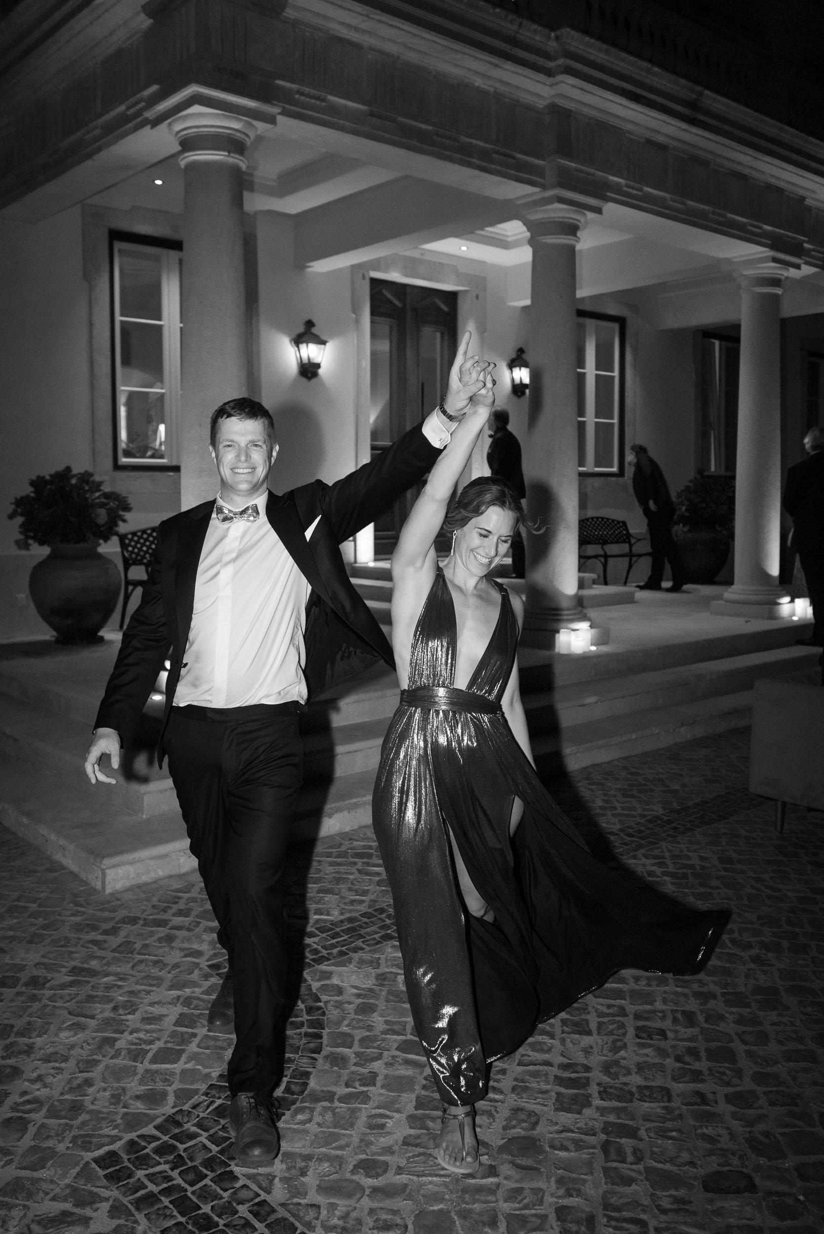 Bride and groom walking to the after-party in front of the palace at Quinta da Bella Vista in Sintra, Portugal