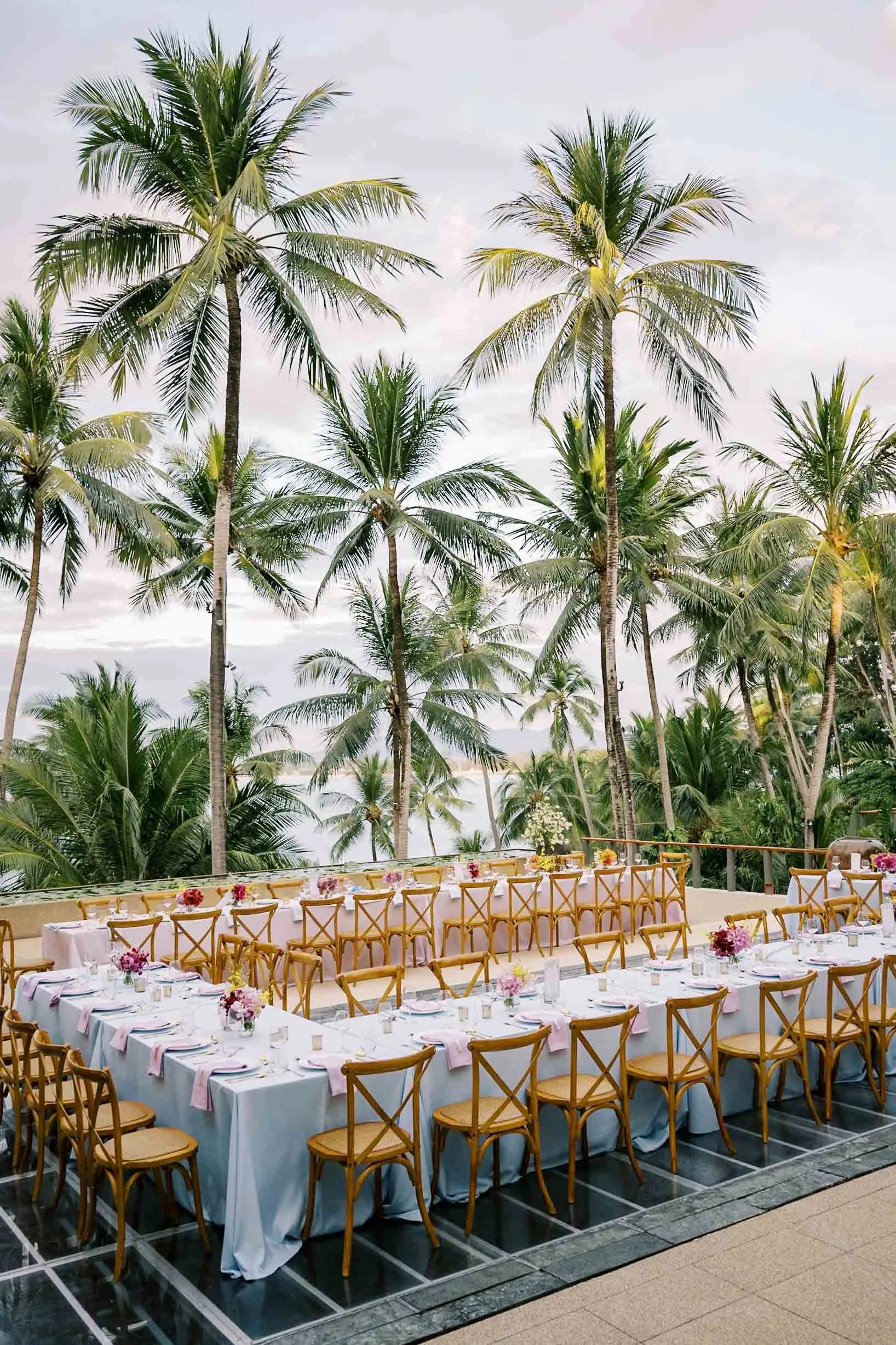Reception dinner table set beneath the palm trees at Amanpuri in Phuket, Thailand