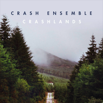 Cover of a music album titled 'Crash Ensemble Crashlands,' featuring a misty forested mountain landscape with a dirt road.