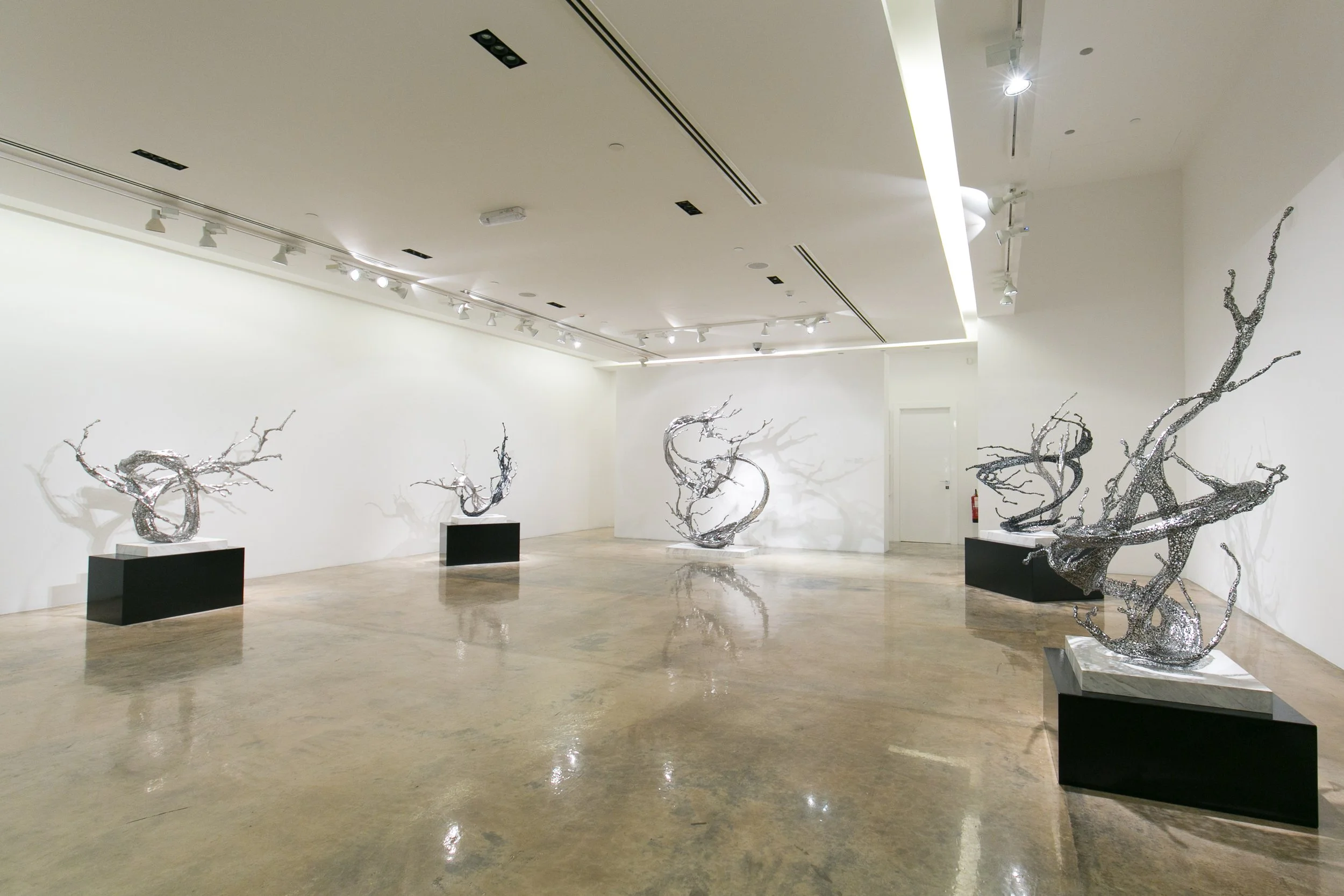 Installation view of Zheng Lu stainless steel sculptures in a contemporary gallery in Qatar