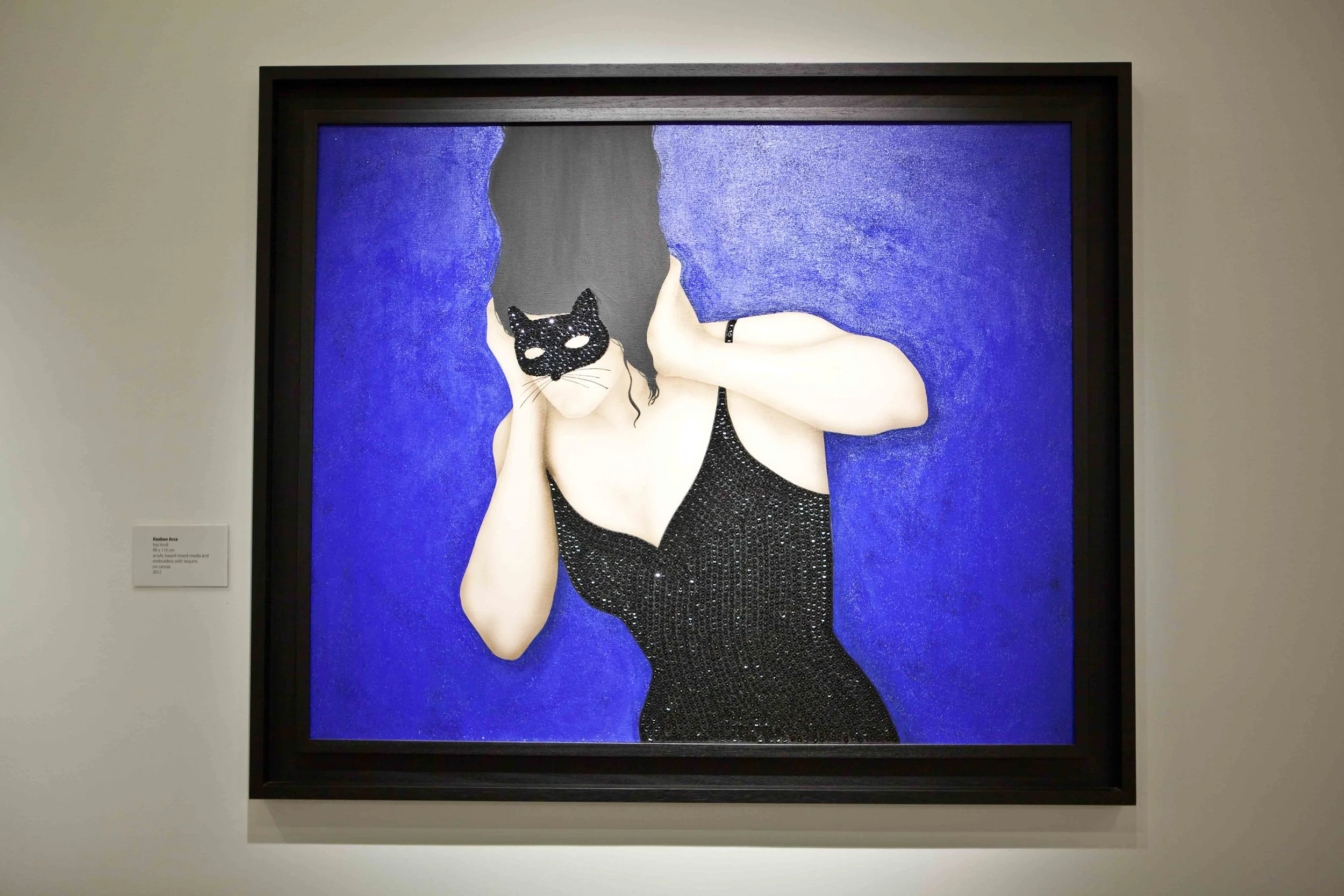 A painting of a woman with dark hair in a black dress with sequins, holding a black cat-shaped mask over her face, against a textured blue background.