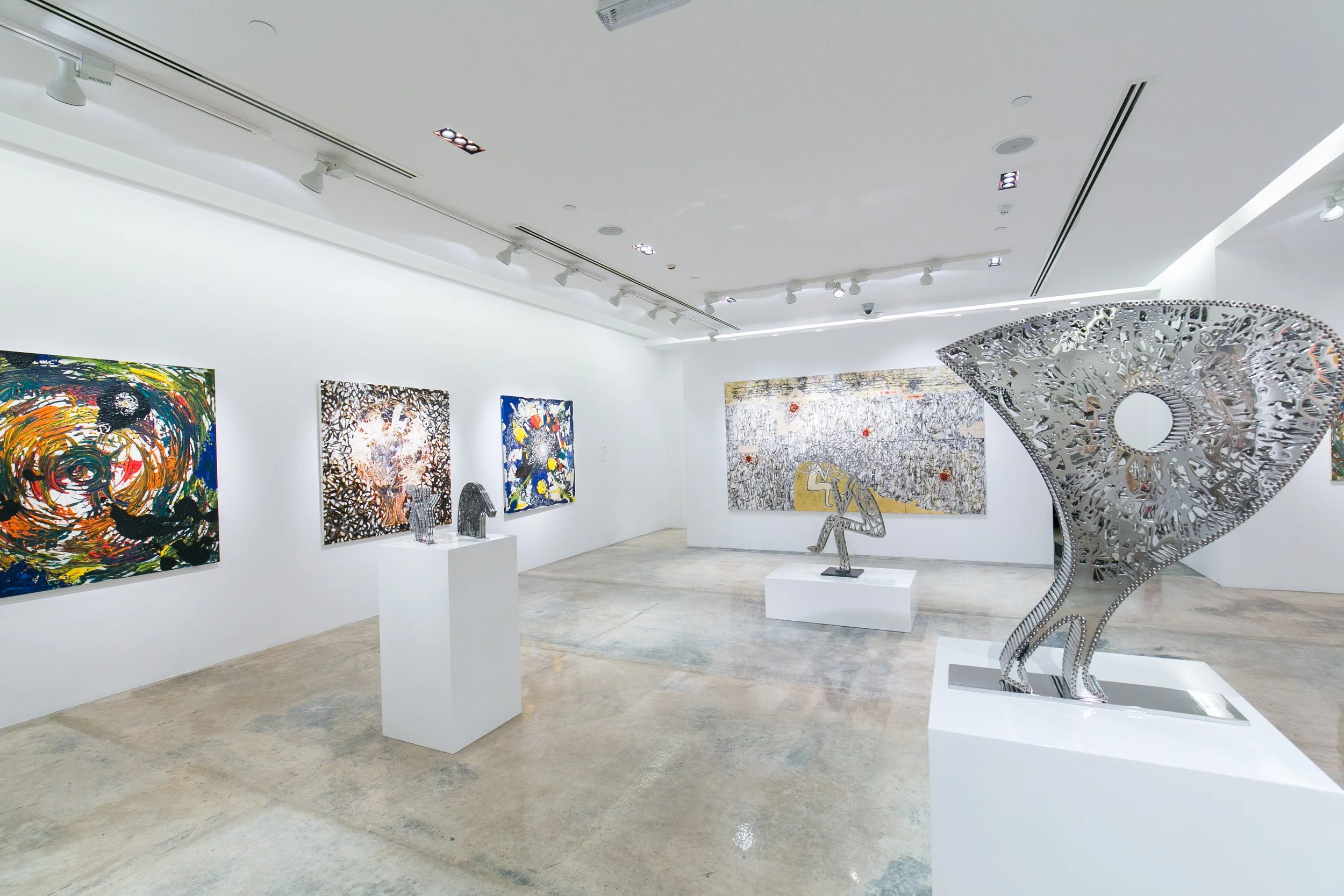 Opening reception for a Nadim Karam solo exhibition in Qatar, featuring contemporary artworks and curated by Mohamad Makouk for Core Art Strategies.