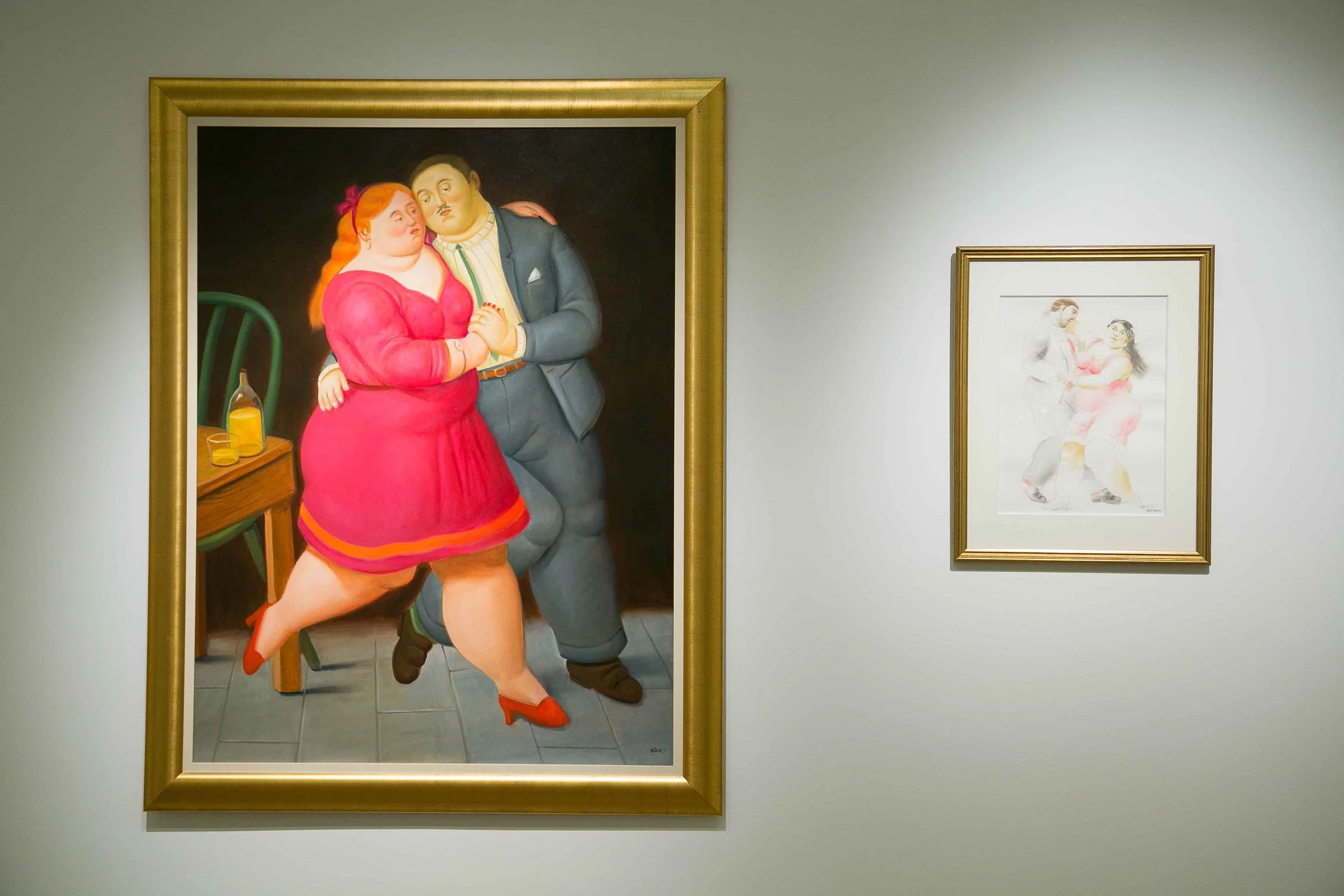 Visitors interacting with a Fernando Botero painting in an exhibition curated by Mohamad Ali Makouk in Qatar