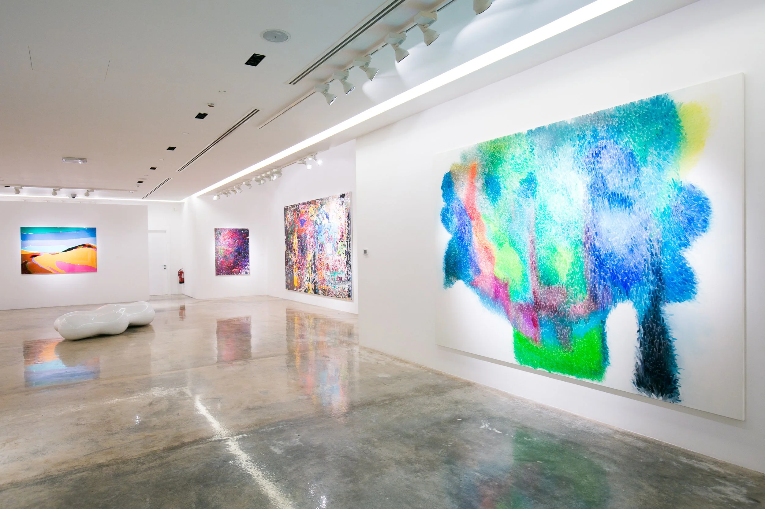 Gallery interior of a Peter Zimmermann exhibition in Qatar, featuring abstract contemporary paintings and exhibition curation by Mohamad Makouk through Core Art Strategies.
