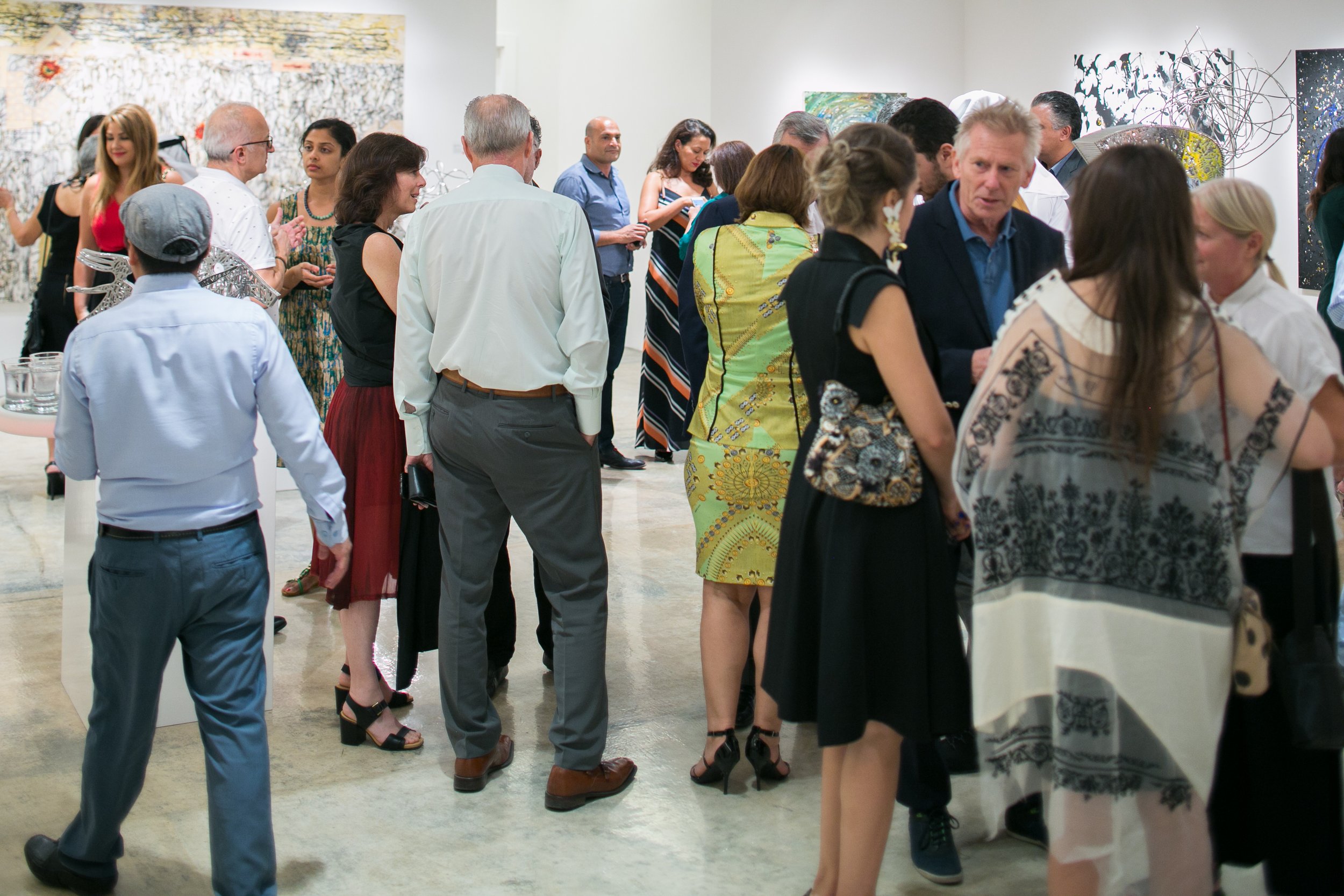 Guests attend a Nadim Karam exhibition in Qatar, highlighting contemporary art, curated presentation, and cultural engagement by Mohamad Makouk for Core Art Strategies.