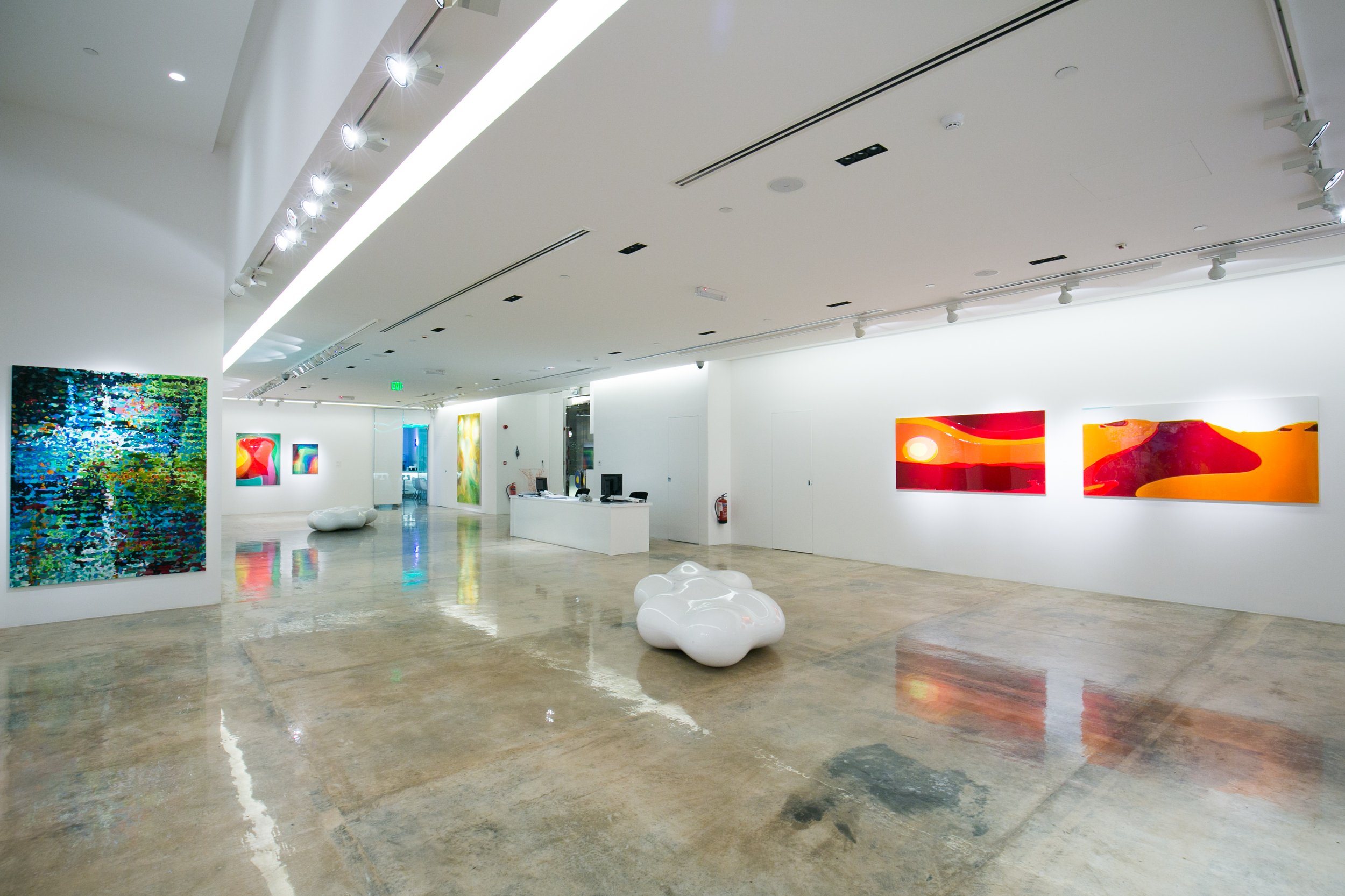 Curated gallery view of Peter Zimmermann’s exhibition in Qatar, highlighting vibrant abstract paintings and the exhibition strategy of Core Art Strategies.
