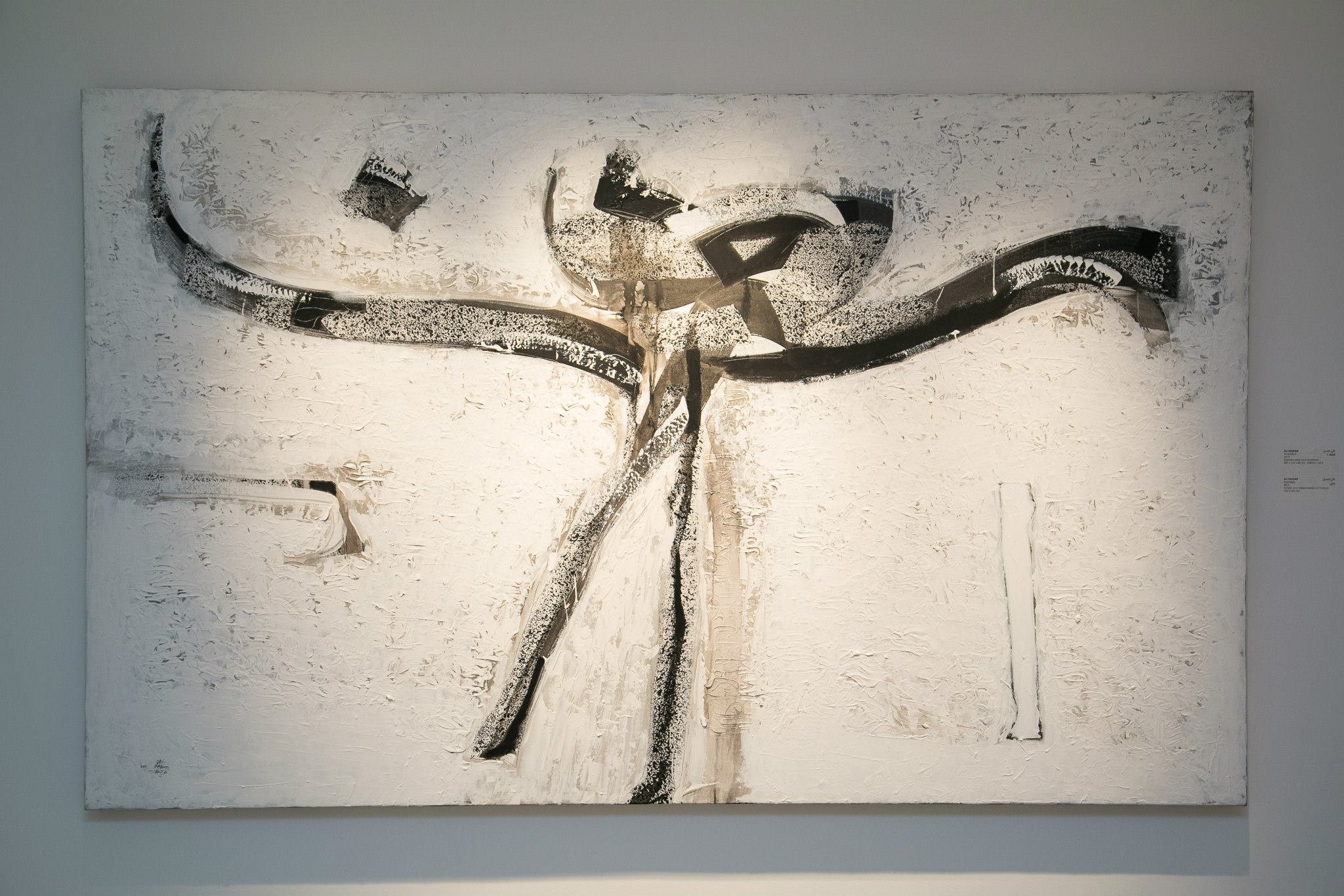 Abstract black and white painting with textured surface, featuring bold curved lines and geometric shapes.