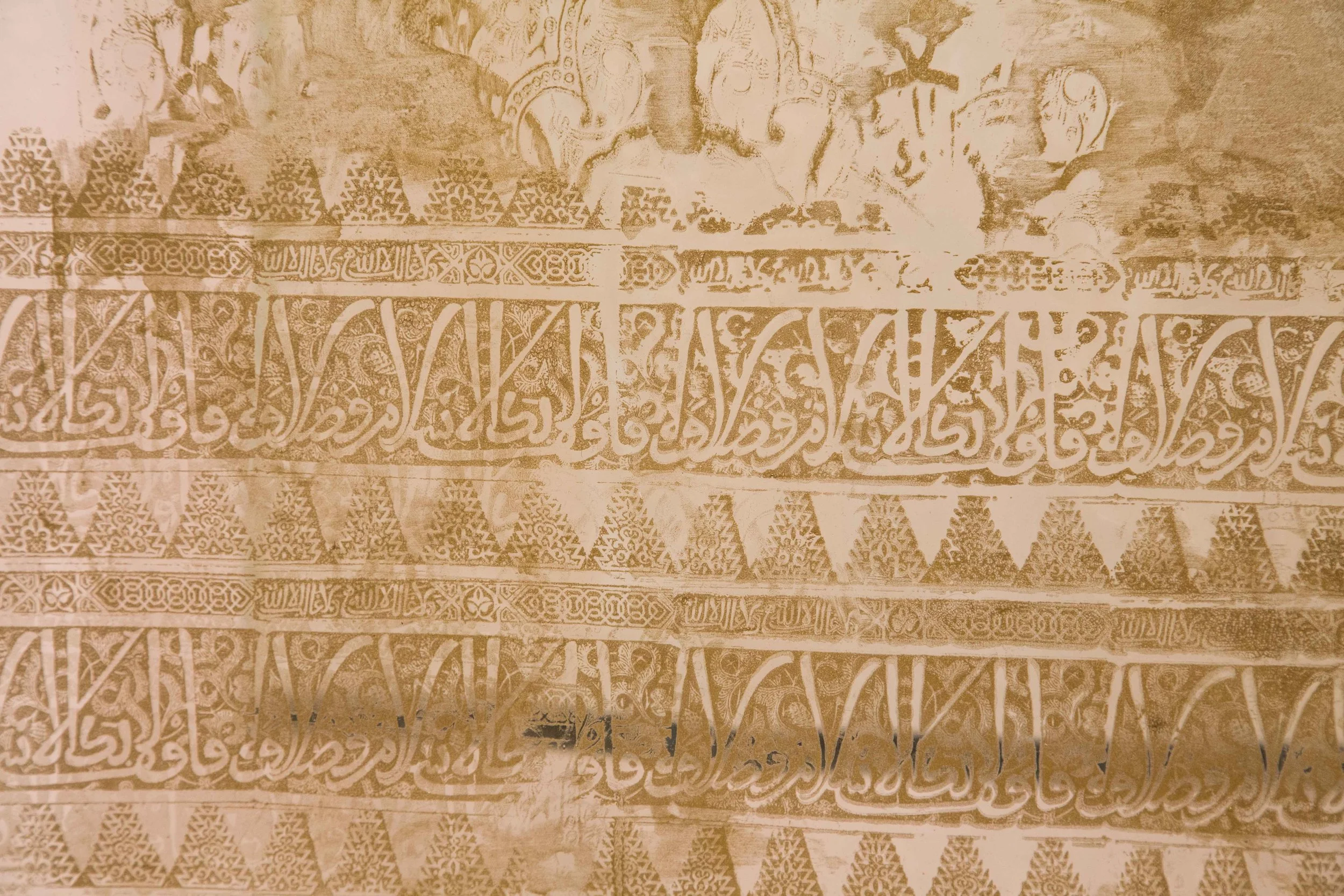 Ancient manuscript with intricate calligraphy and geometric patterns in a sepia tone.