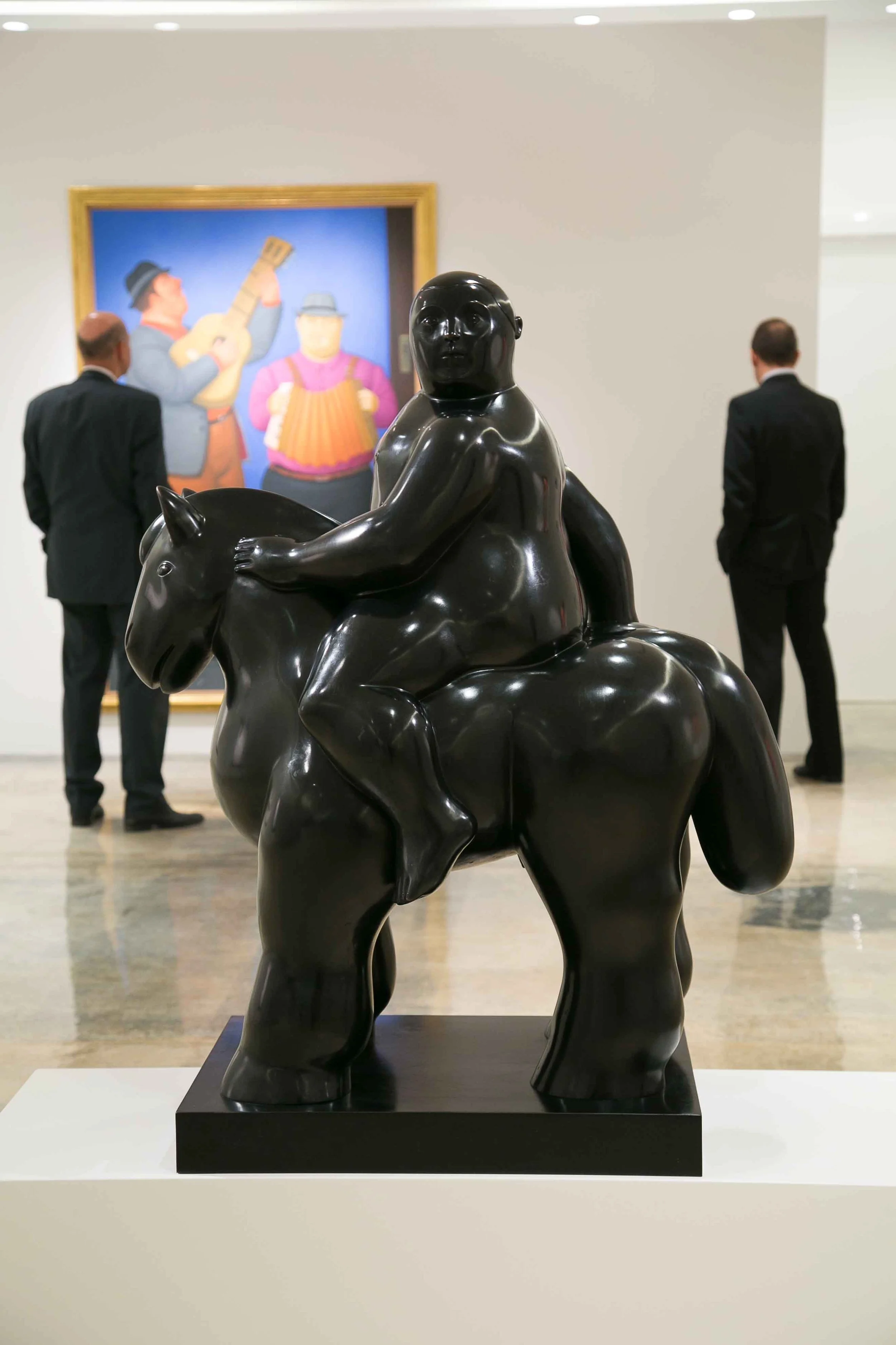 Gallery visitors viewing Fernando Botero works curated by Mohamad Ali Makouk in Qatar