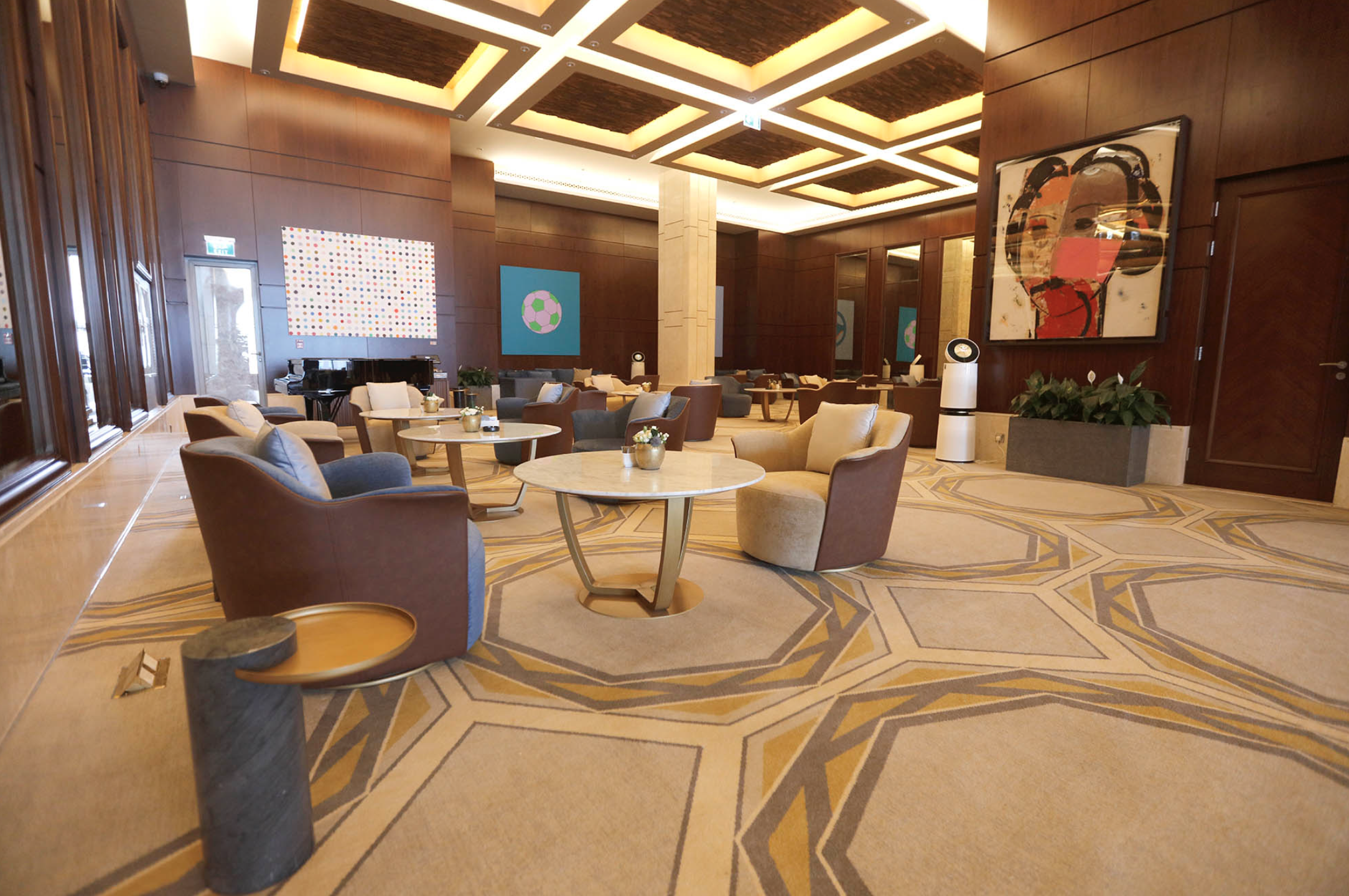 Lobby of St. Regis Marsa Arabia Private Island, Doha featuring artworks by Damien Hirst, Manolo Valdés, and Michael Craig-Martin curated as part of the hotel’s art program by Core Art Strategies.