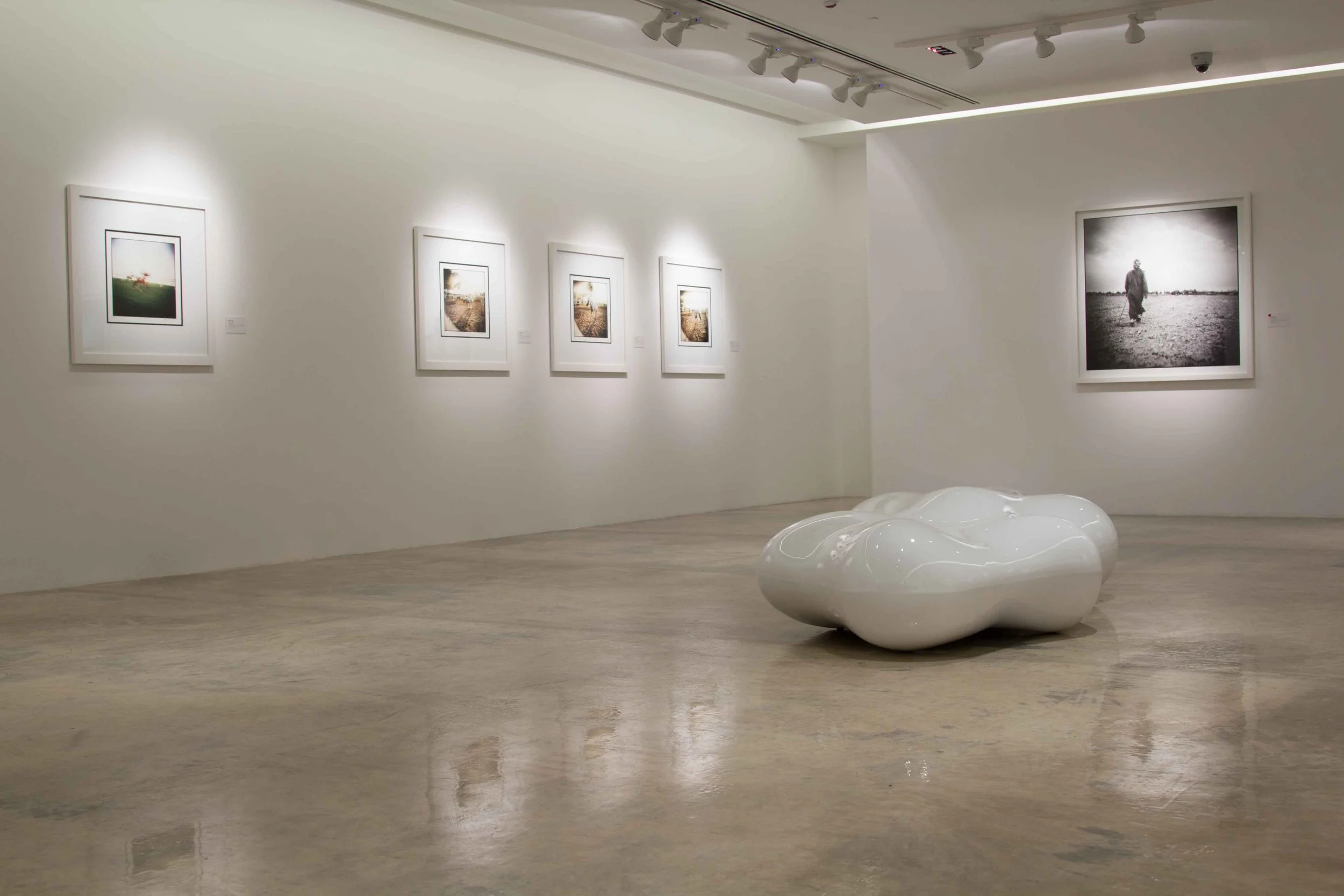 Gallery view of Maher Attar’s exhibition in Qatar, curated by Mohamad Makouk for Core Art Strategies, featuring framed photographic works in a contemporary white-cube setting.