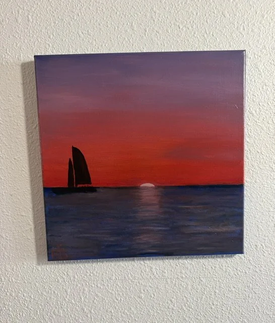 Crimson Passage, a 14 x 14 original oil sailboat sunset painting by Bonnie Seide, displayed on a wall.