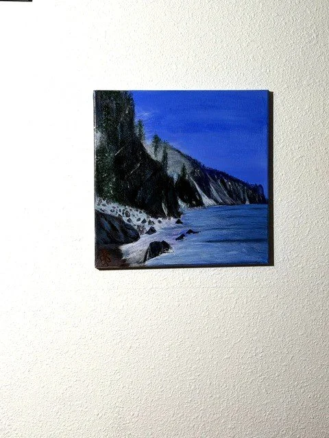 Alpine Stillness, a 14 x 14 original acrylic mountain landscape by Bonnioe Seide, displayed on a wall.