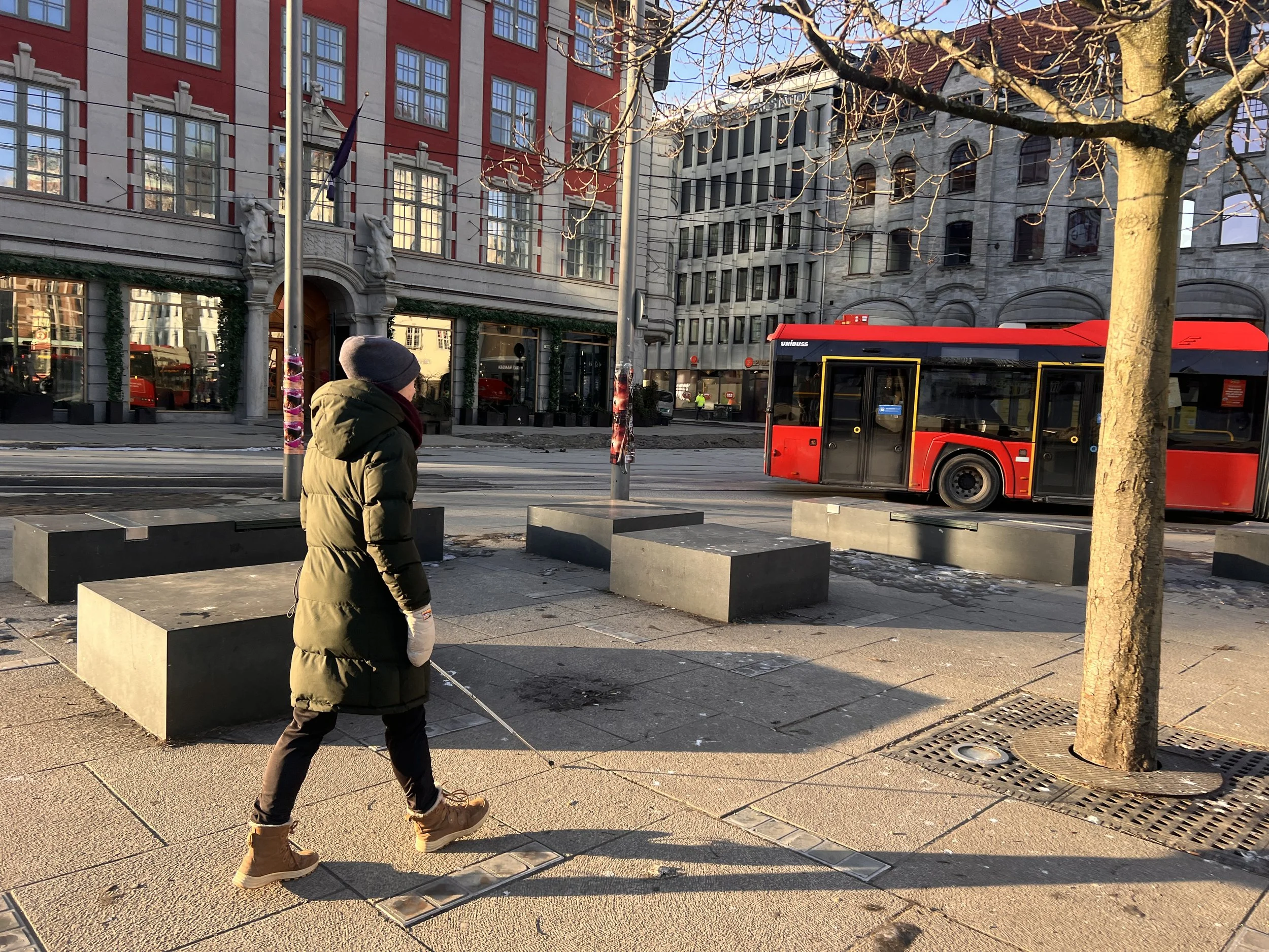 An image of a person walking with a mobility stick..