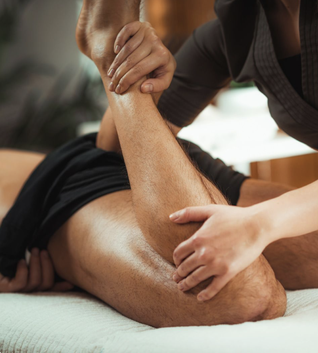 A person receiving a massage on their leg from a massage therapist.