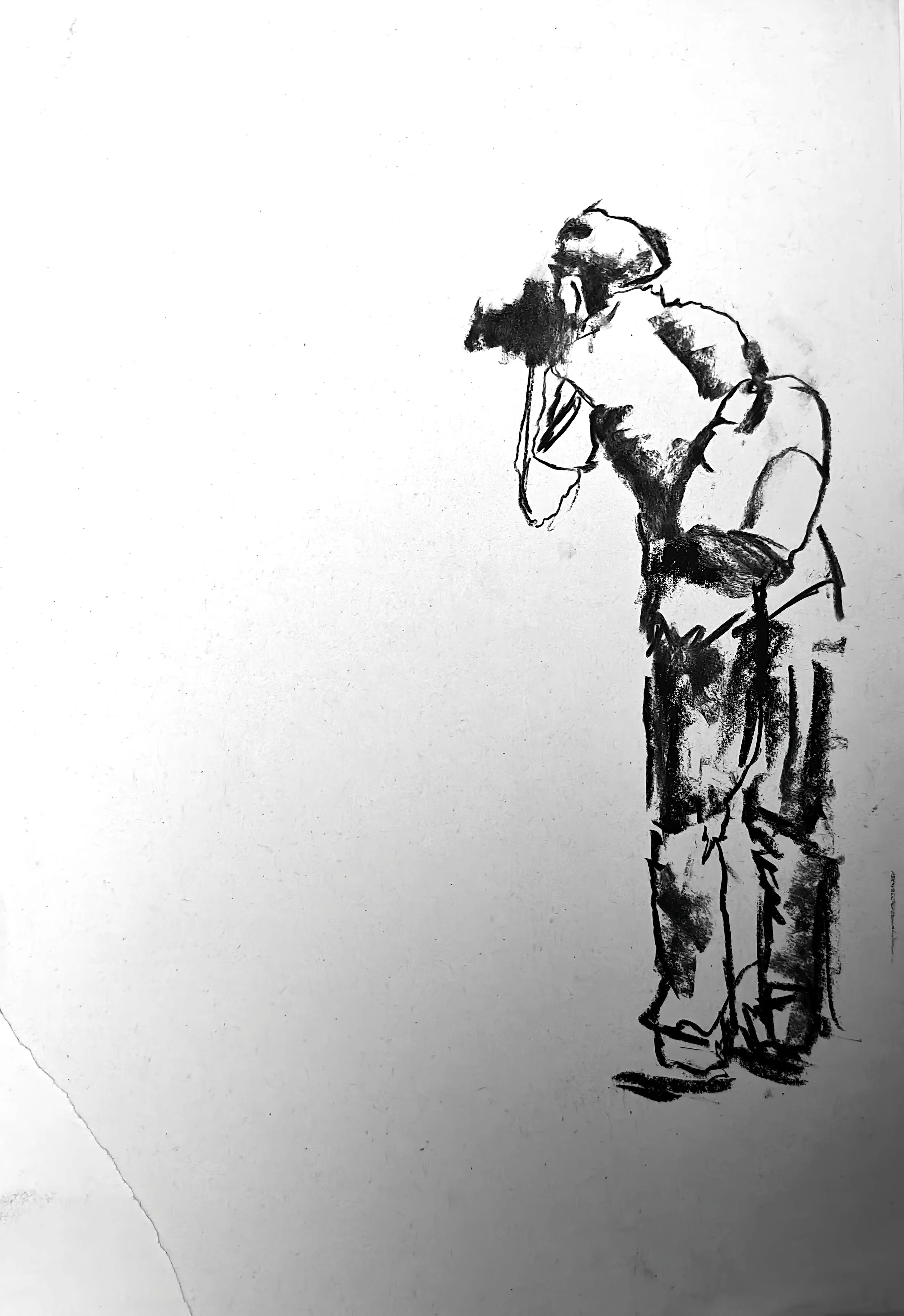 Charcoal figure drawing by Shaun Bell. Contemporary minimalist figurative artwork exploring urban isolation, anonymous city life, and human transience. Expressive tonal charcoal on paper with strong negative space and gestural mark-making.