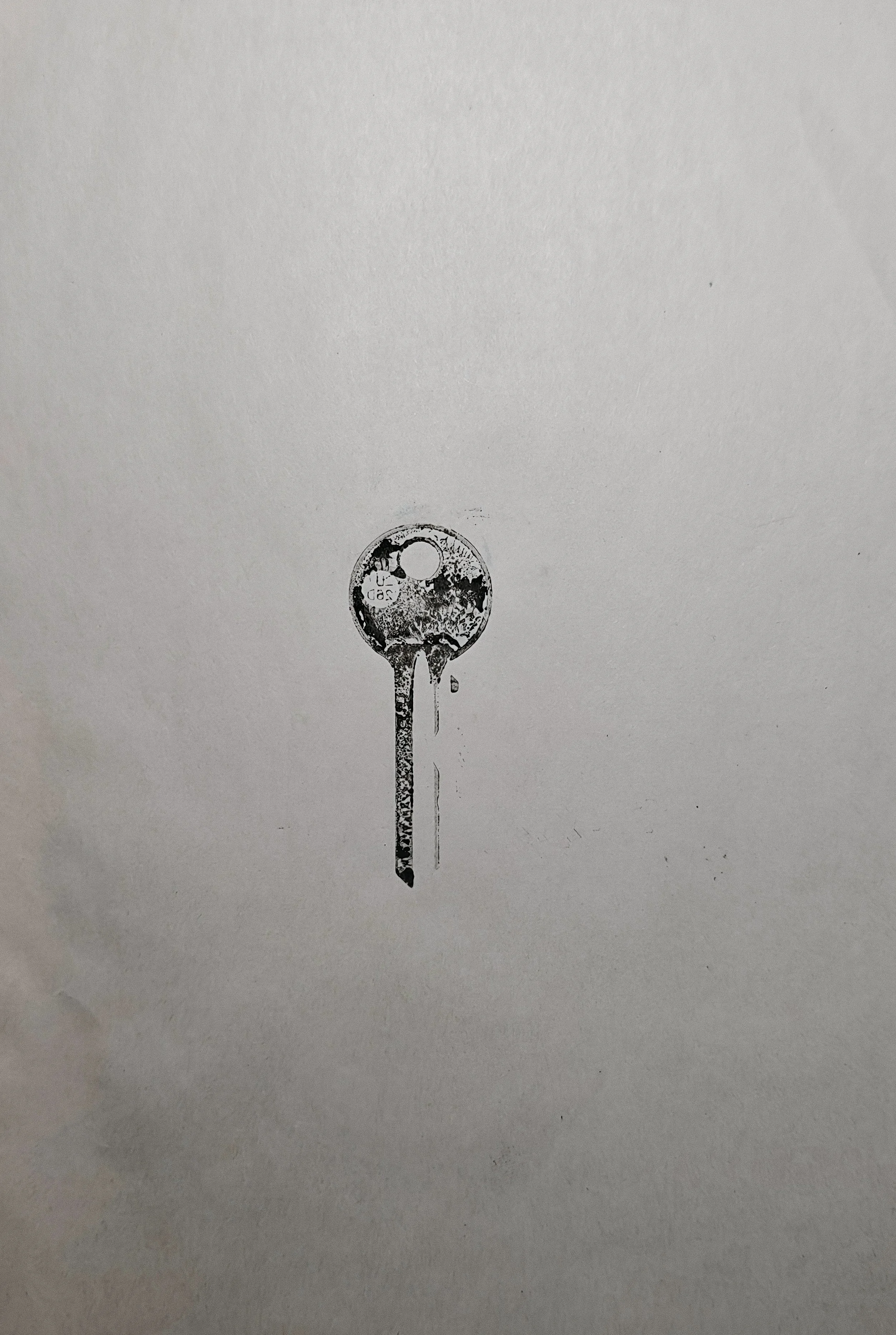 Artwork by Shaun Bell featuring a black and white print of a key.