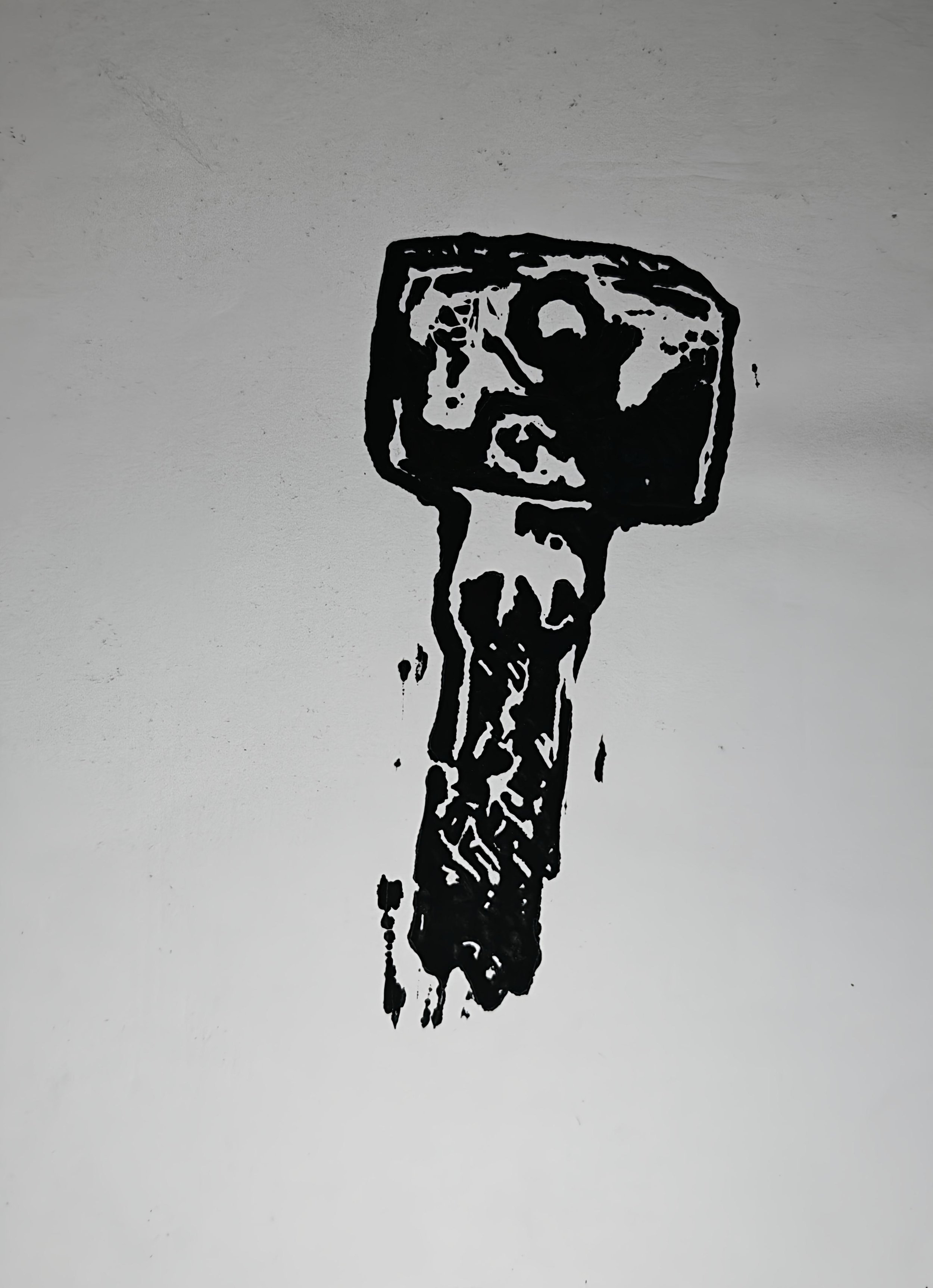 Artwork by Shaun Bell featuring a black and white lino print of a singular key.
