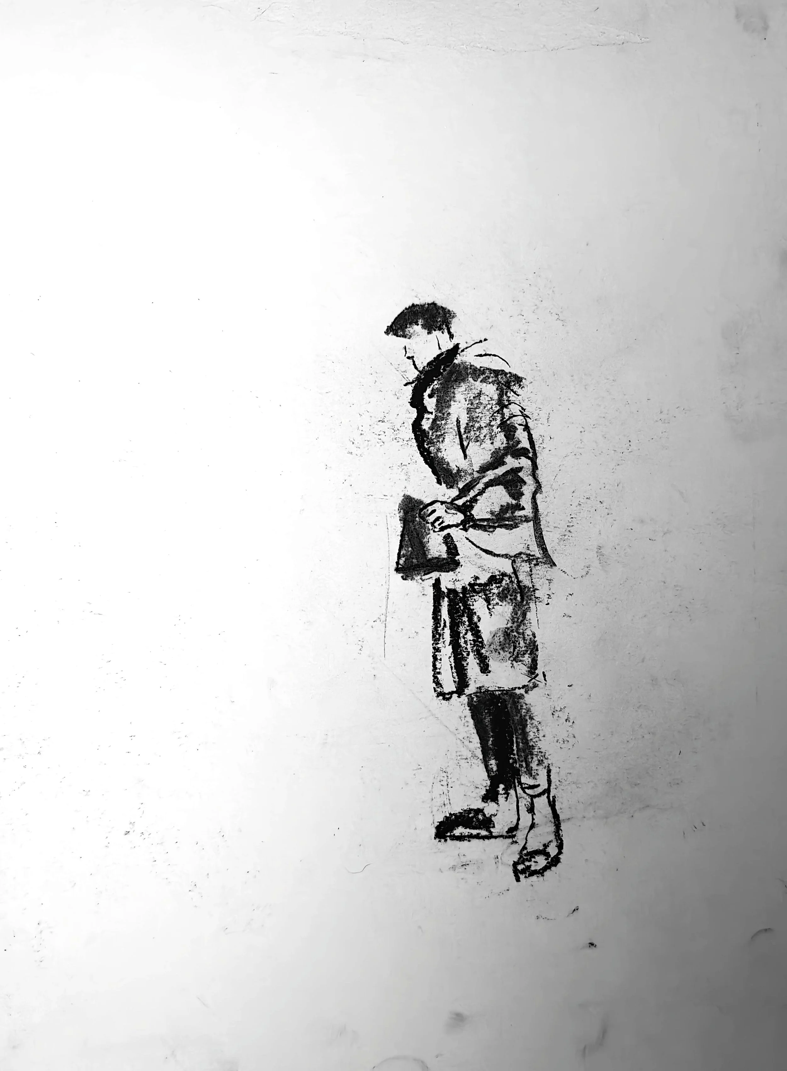 Charcoal figure drawing by Shaun Bell. Contemporary minimalist figurative artwork exploring urban isolation, anonymous city life, and human transience. Expressive tonal charcoal on paper with strong negative space and gestural mark-making.