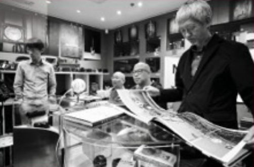 People browsing books and magazines in a bookstore or library.