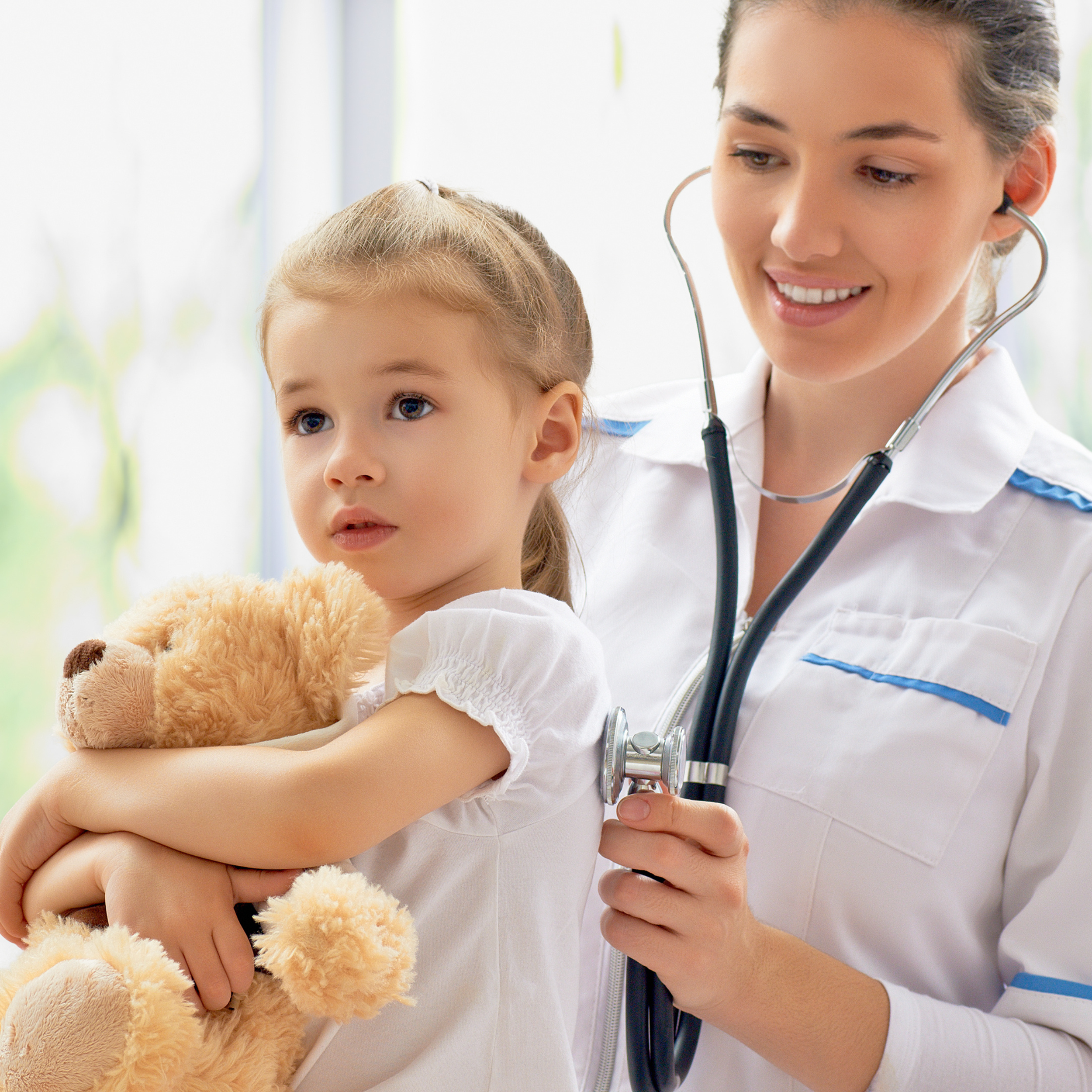 Pediatrician With Kid Holding A Teddy Bear
