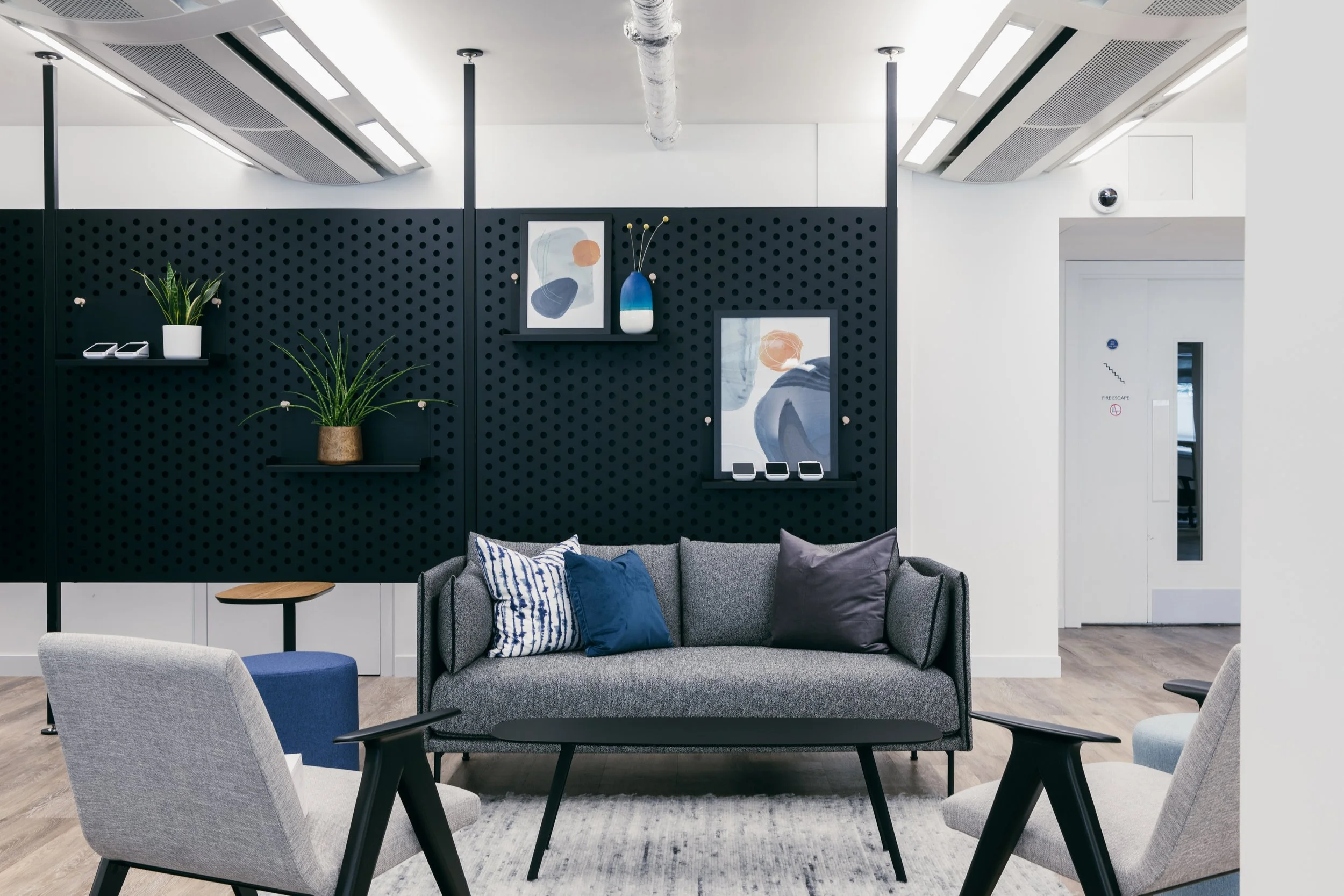 Breakout lounge with pegboard wall, designed by Ellipse