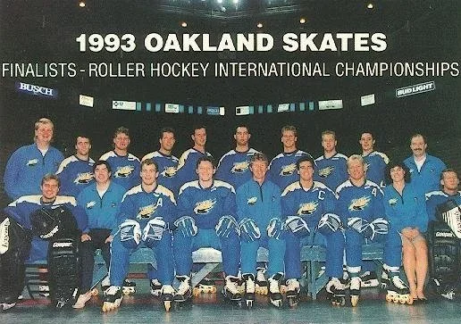 Group photo of the 1993 Oakland Skates hockey team at the Roller Hockey International Championships on an indoor rink with a scoreboard and banners in the background.