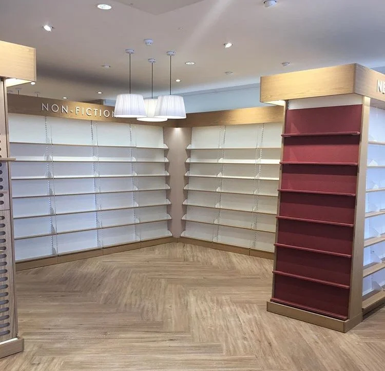 Empty bookstore shelves with a section labeled Non-Fiction, store now vacant.
