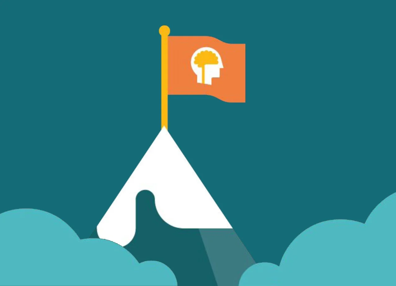 A stylized mountain with a flag at the top, featuring a human head silhouette with a brain inside and a plant sprout on top.