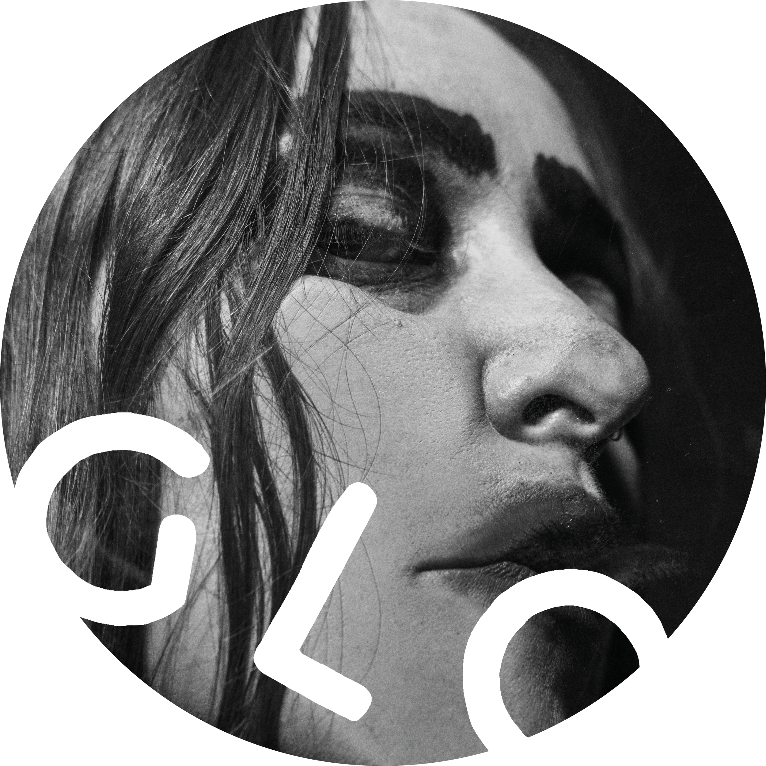 Close-up black and white photo of a woman's face with dark makeup, focusing on her nose, lips, and eye, with large white text overlay reading "CLOS".