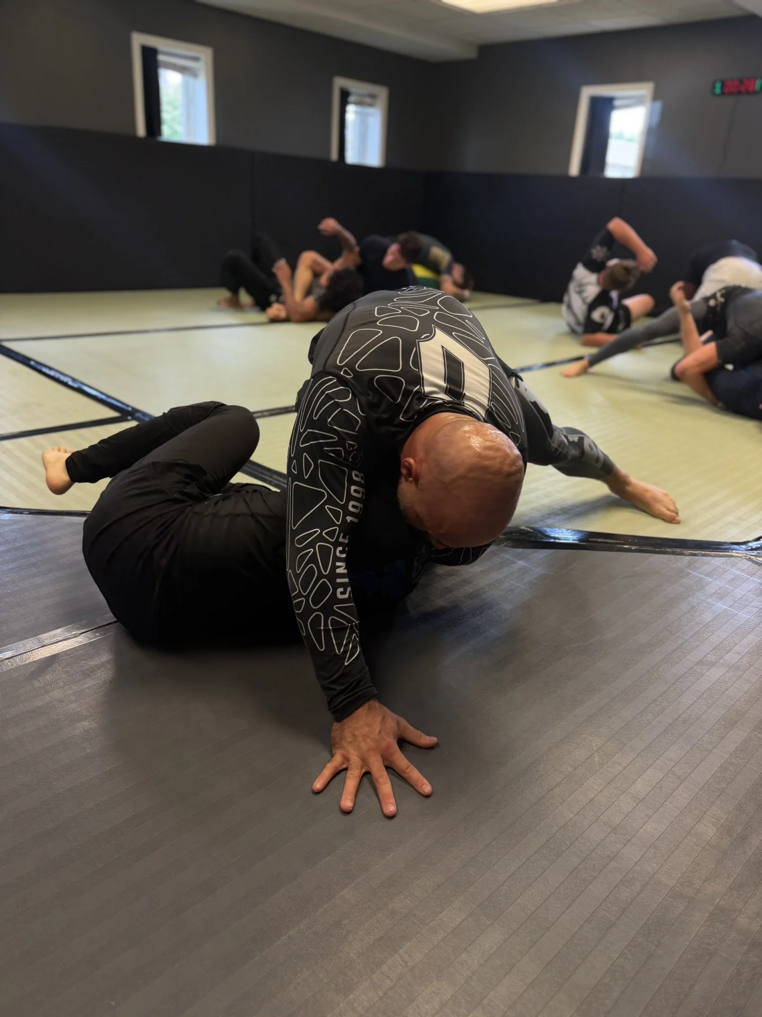 Adult No-Gi jiu-jitsu class training at The Garage Jiu-Jitsu in Commerce Township, Michigan.