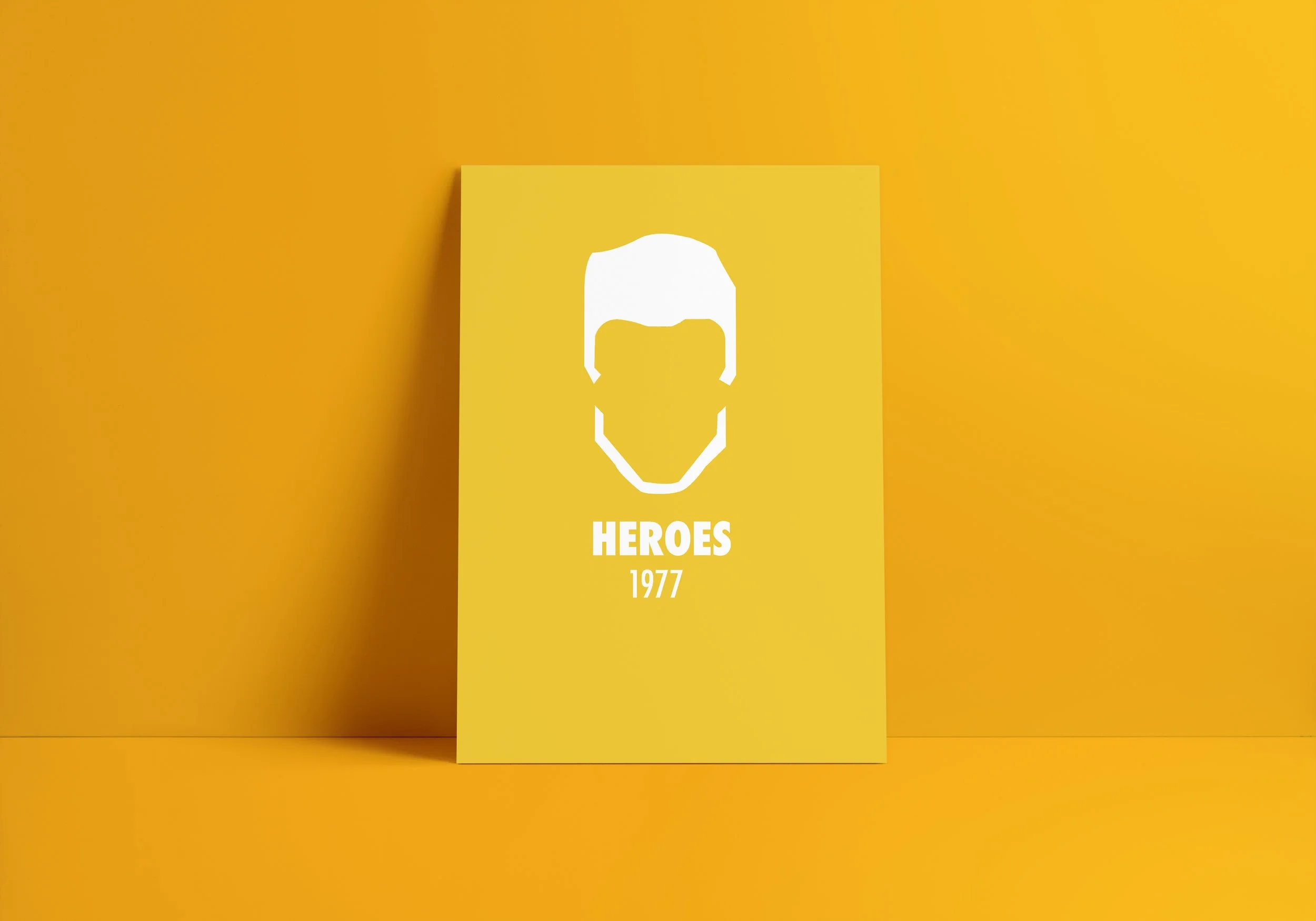 Graphic design. Cronology David Bowie. A yellow card with a white minimalist illustration of a male hero's face and hair, titled "HEROES 1977" in white text.