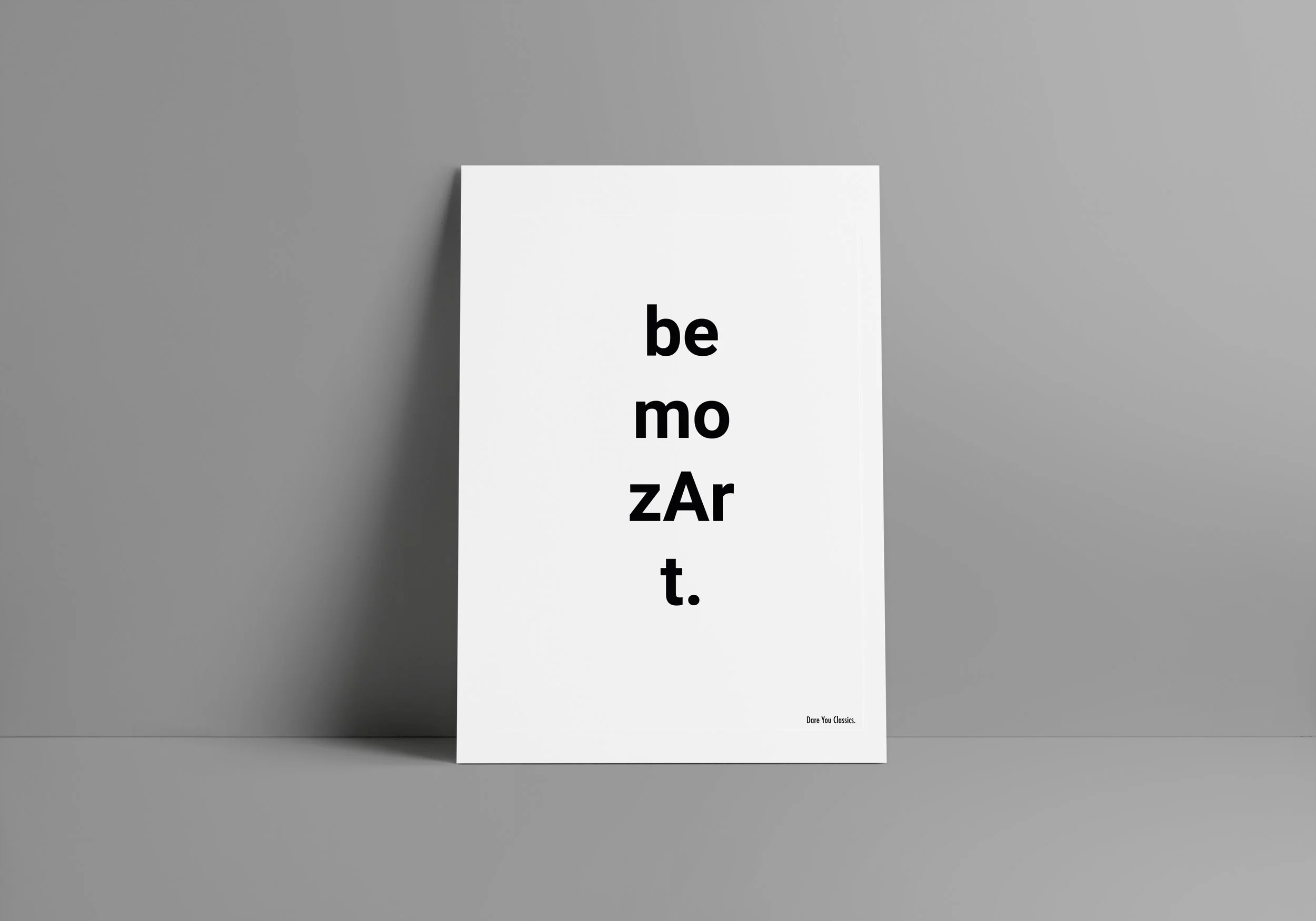 Graphic design. Classical music claims. A white poster with black text on a gray background. The text reads 'be mo zAr t.' with a small note in the bottom right corner that says 'Dare You Classics.'