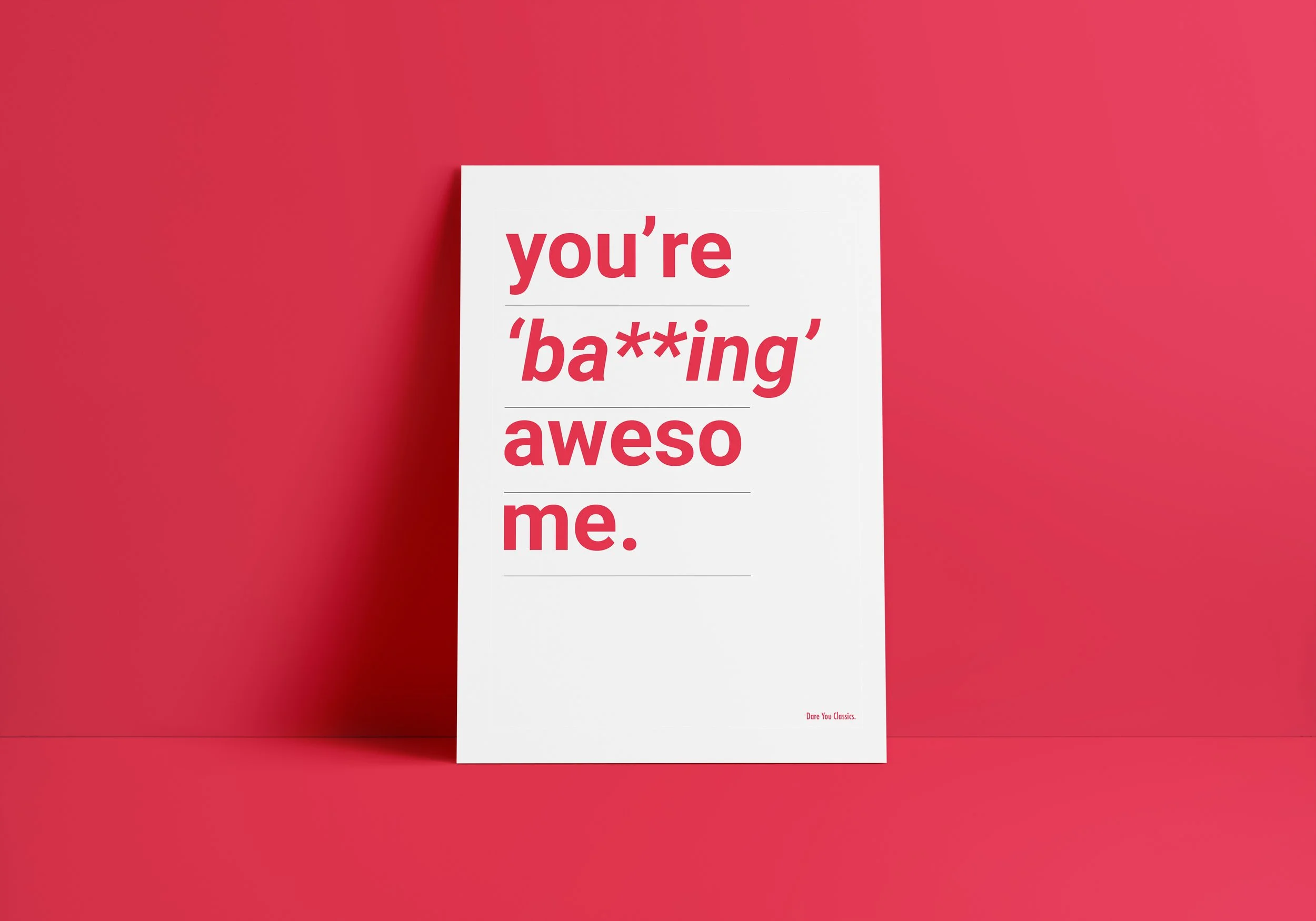 Graphic design. Classical music claims. A white card with bold red text reading "you're 'ba**ing' asome me." positioned against a pink wall and pink surface.