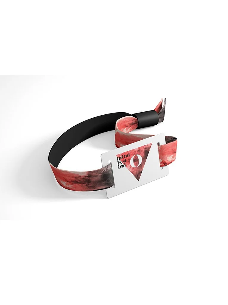 Graphic design. End-of-degree project. A wristband with black and red marble patterns and a ticket attached, referencing the Montreal Festival.