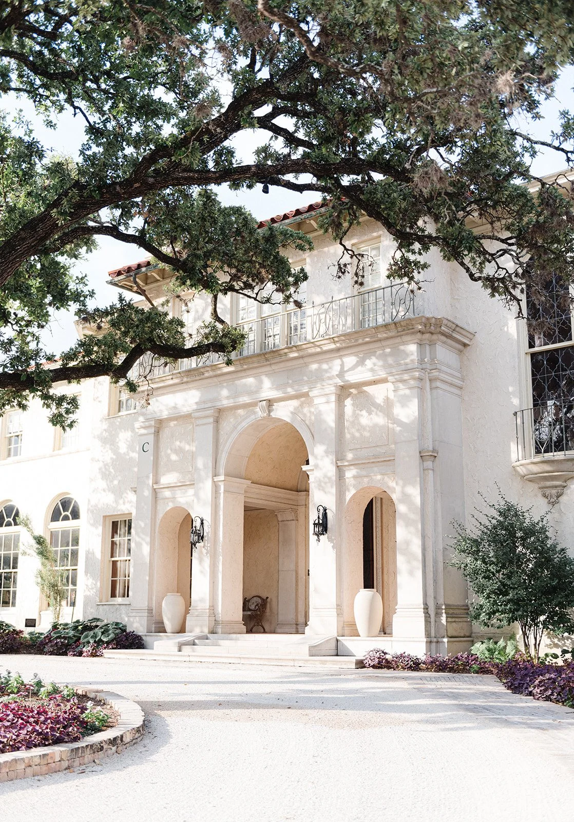 Laurie’s customers, Mariana and Carmen holding hands on a green lawn on their wedding day.