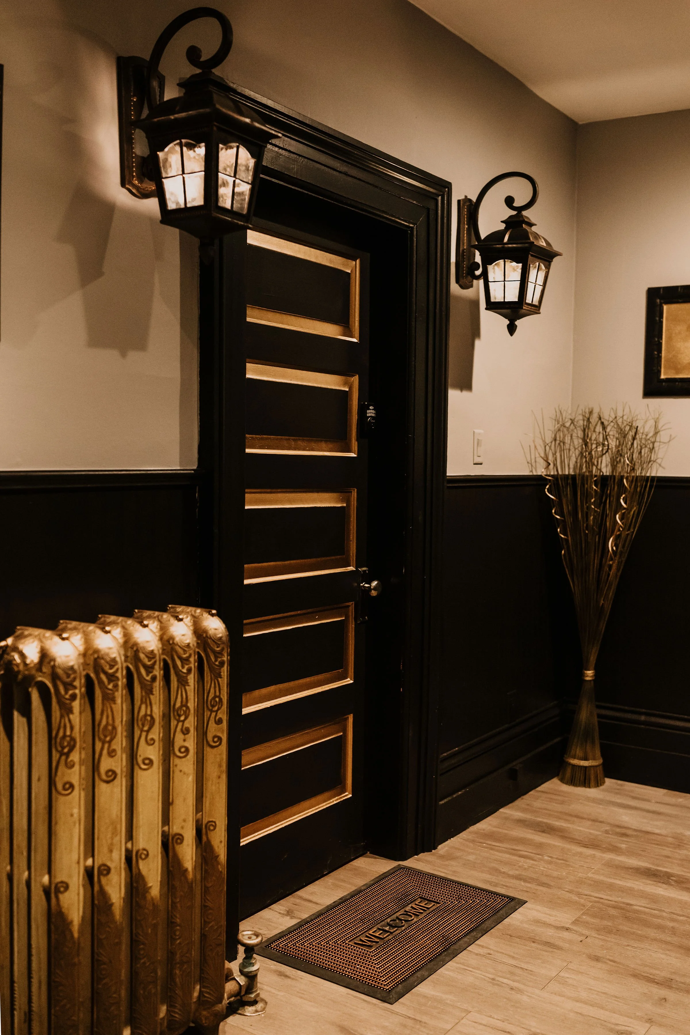 Entrance door and foyer with vintage radiator at Sir Sanford Loft On Main in Collingwood