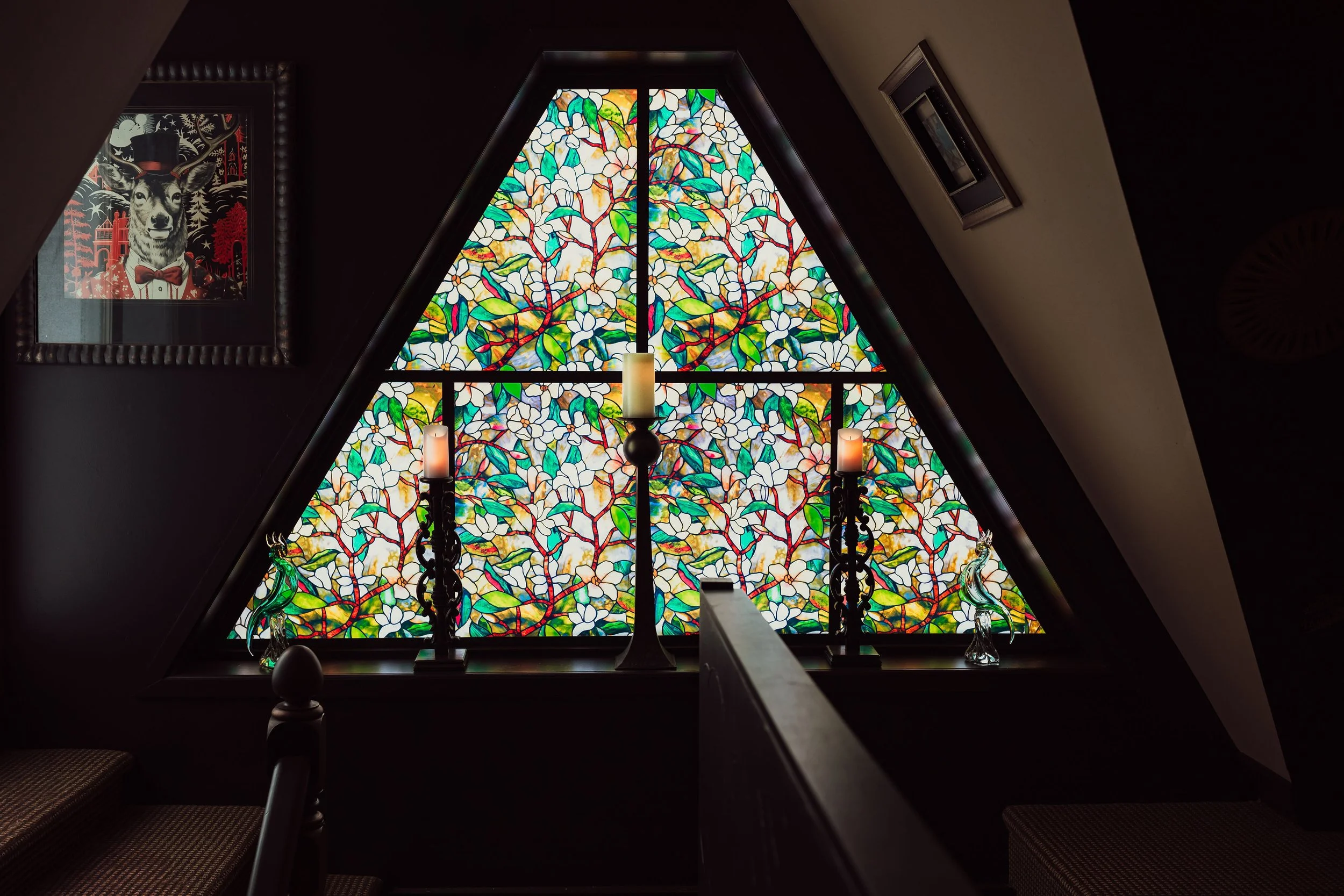 Stained glass window feature with architectural detail inside Sir Sanford Loft On Main in Collingwood