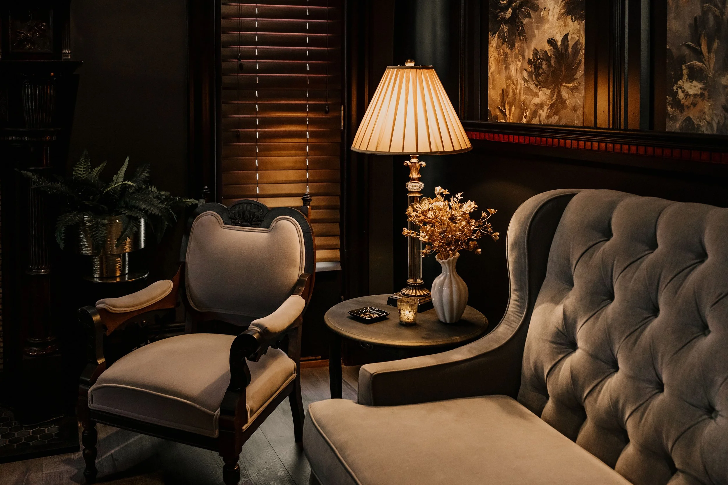 Vintage lounge seating with fireplace and warm lighting at Sir Sanford Loft On Main in Collingwood