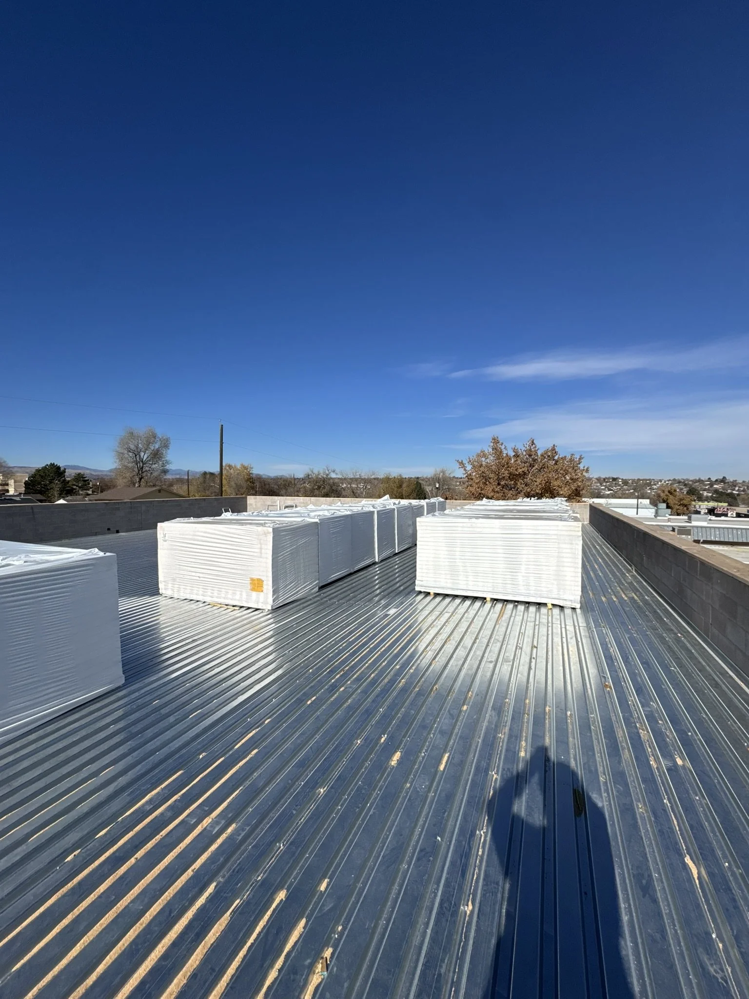 Metal roof with under a clear blue sky.