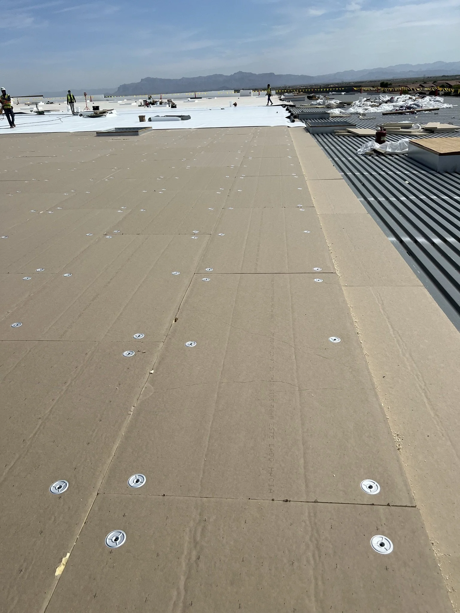 Colorado commercial roof with blue sky in the background.